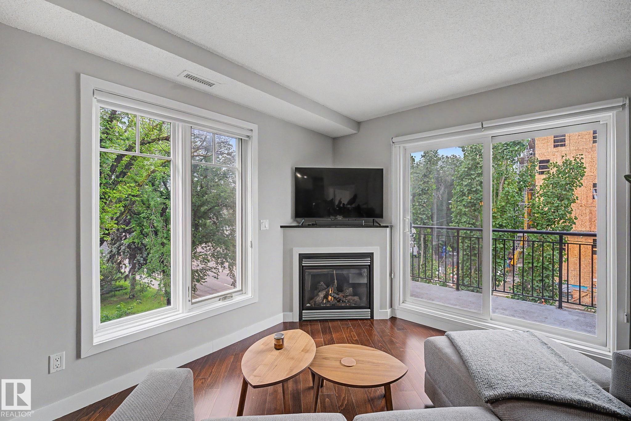 #307 7907 109 St Nw, Edmonton, AB - Indoor Photo Showing Living Room With Fireplace
