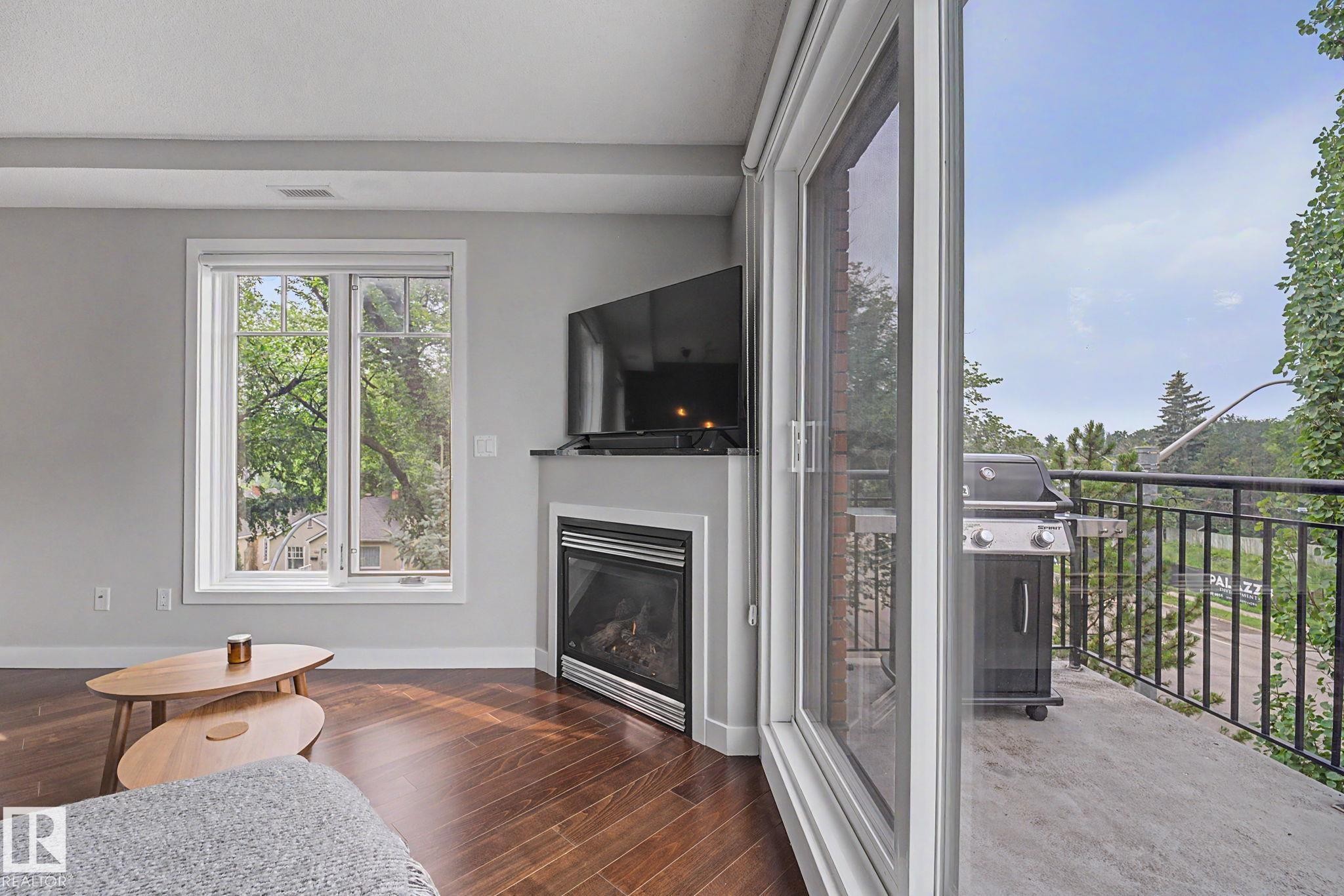 #307 7907 109 St Nw, Edmonton, AB - Indoor Photo Showing Living Room With Fireplace