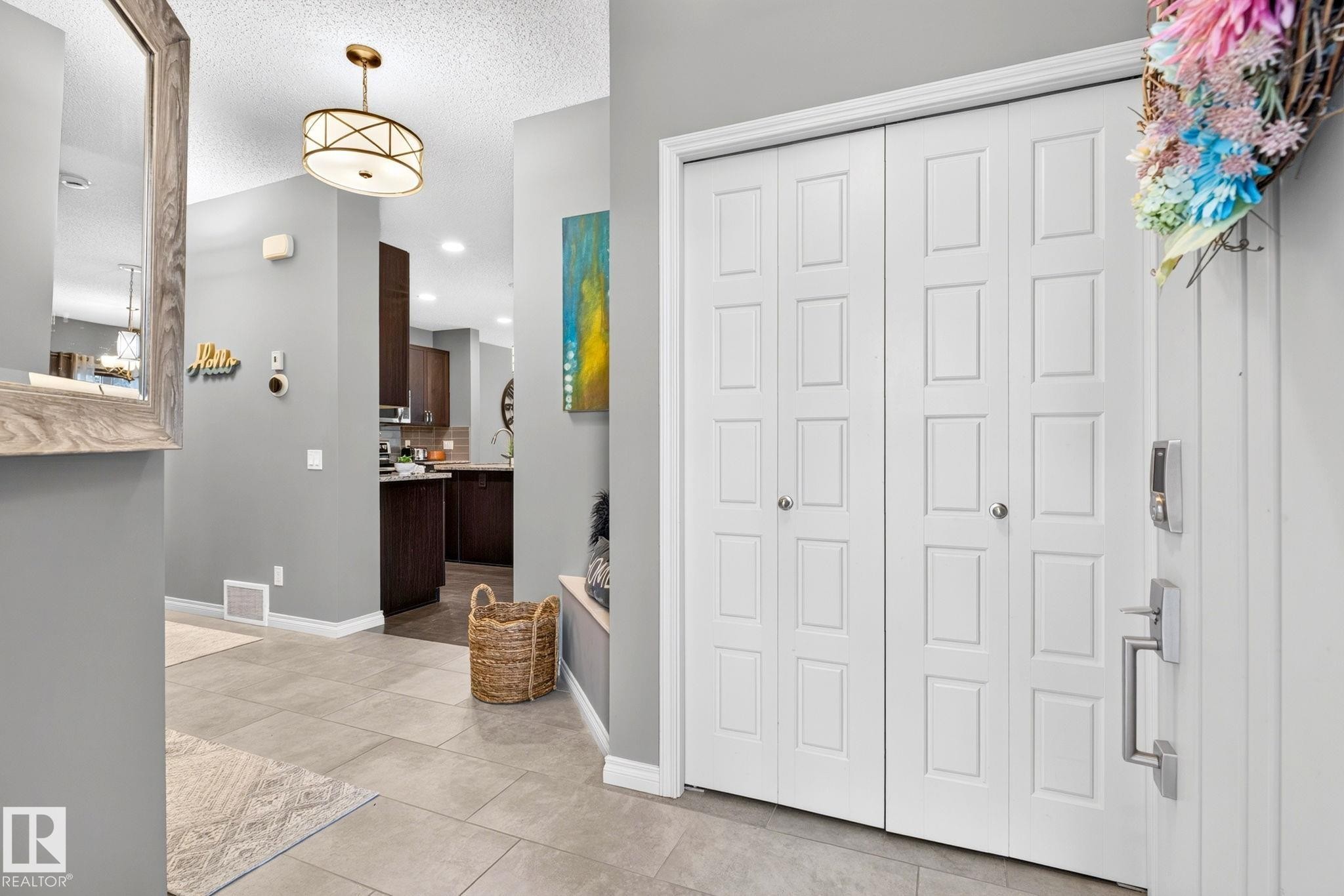 Entryway featuring neutral wall colors, recessed lighting, tile flooring, and a decorative semi-flush mount ceiling fixture - 16512 140 Street Nw, Edmonton, AB - Indoor Photo Showing Other Room