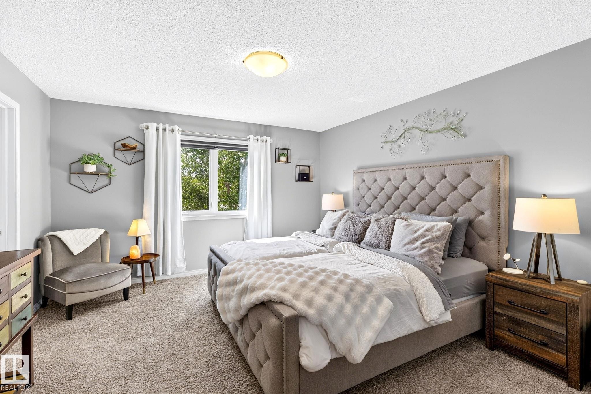 Plush wall-to-wall carpeting, window with natural light, neutral wall colors, and a ceiling-mounted light fixture - 16512 140 Street Nw, Edmonton, AB - Indoor Photo Showing Bedroom