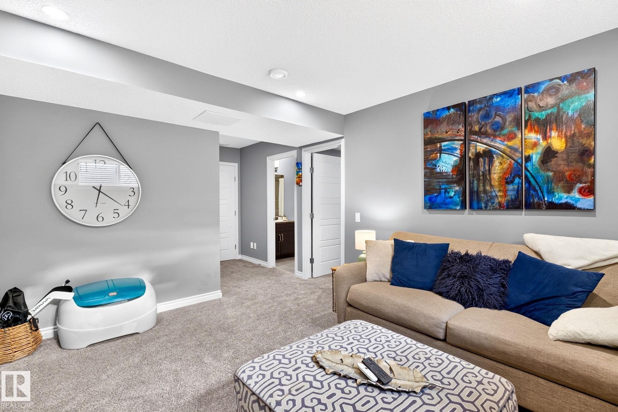 Recessed lighting illuminates neutral gray walls and plush gray carpeting - 16512 140 Street Nw, Edmonton, AB - Indoor Photo Showing Living Room