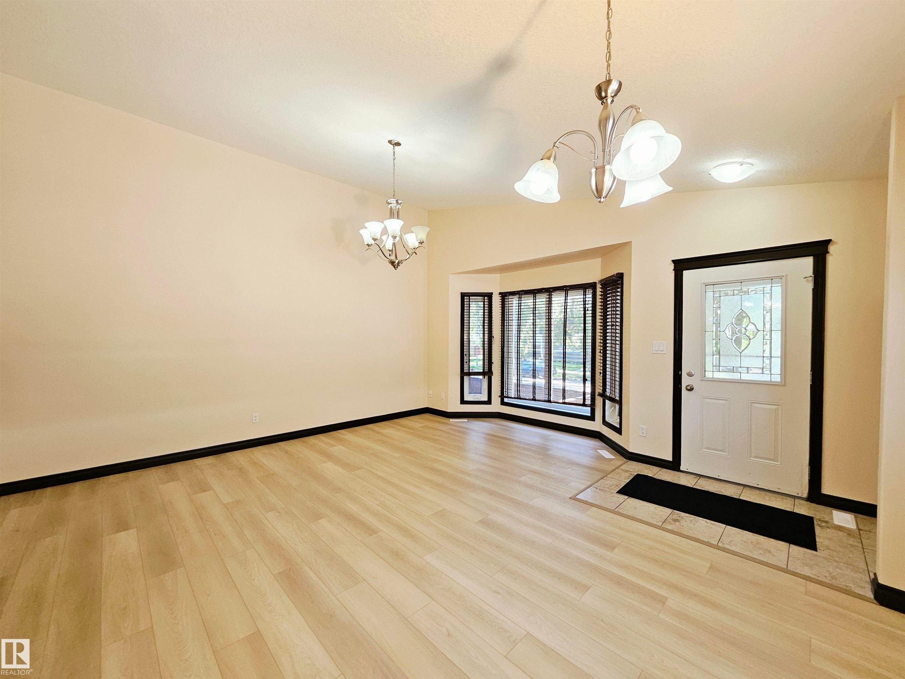 Light wood-finish flooring with a tiled entryway - 11625 88 Street Nw, Edmonton, AB