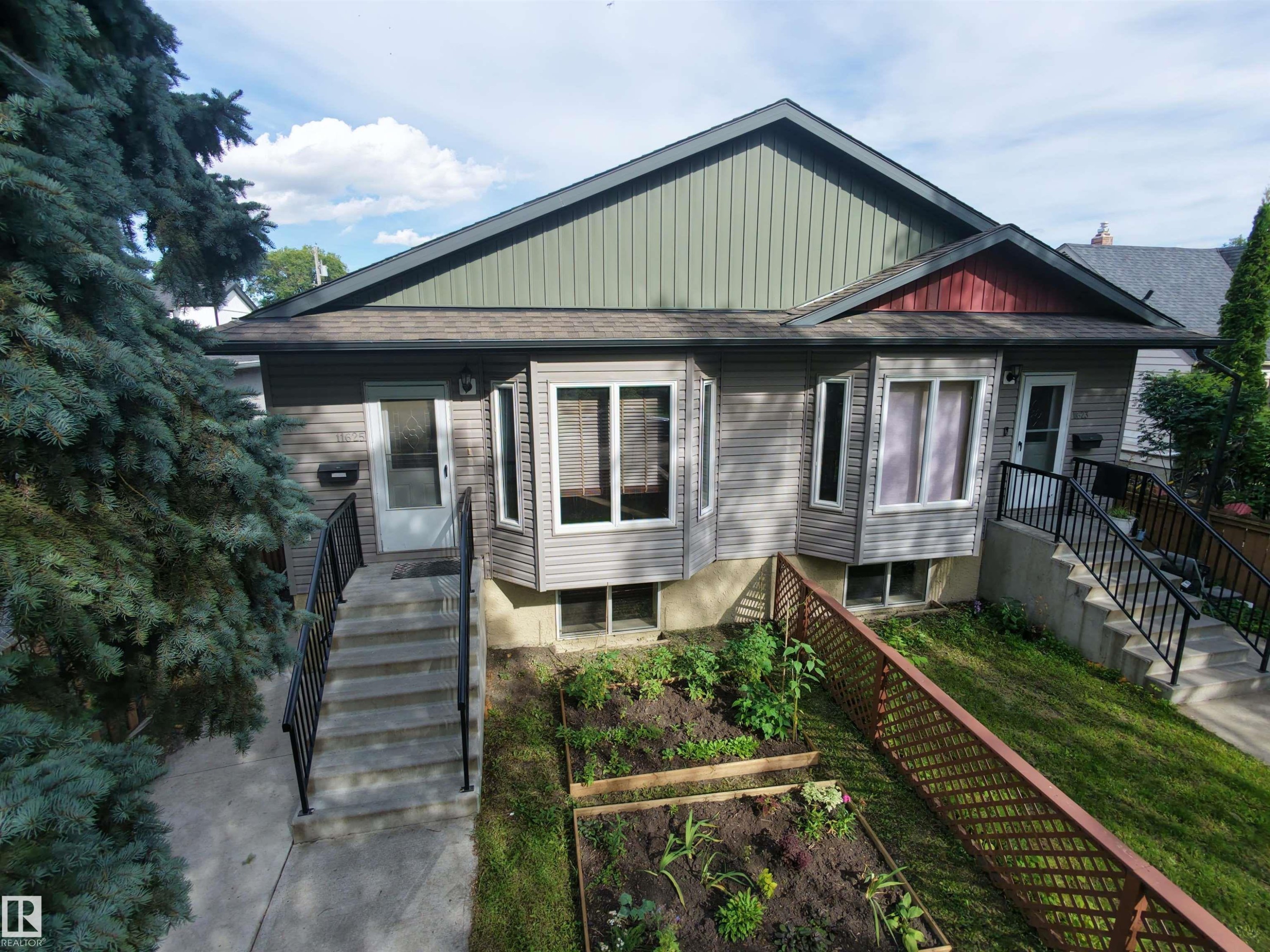 Two distinct entryways with concrete steps and black railings - 11625 88 Street Nw, Edmonton, AB