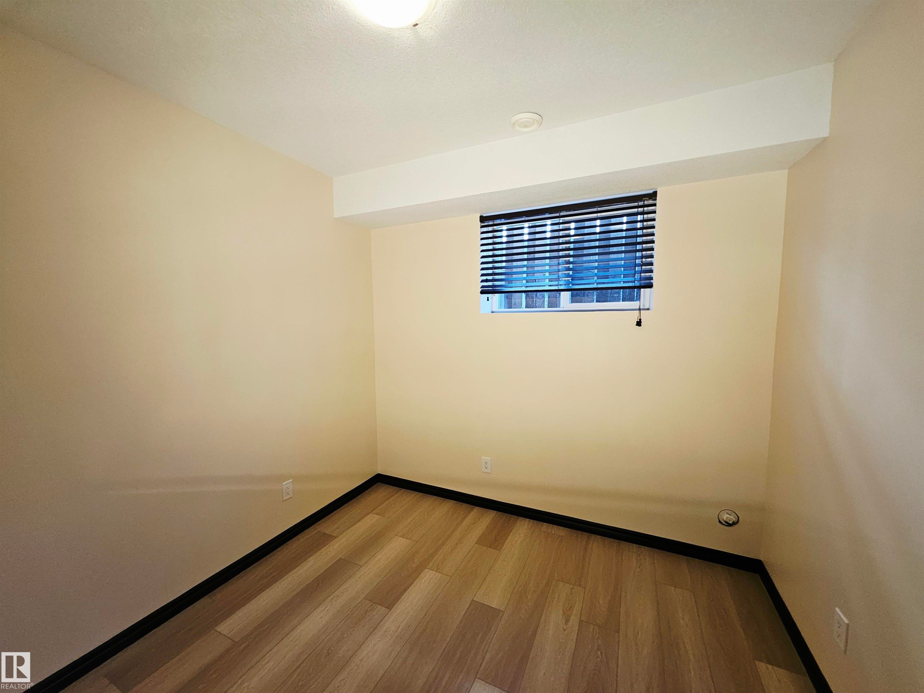 Recessed lighting, wood-finish flooring, neutral-toned walls, and a window with blinds - 11625 88 Street Nw, Edmonton, AB