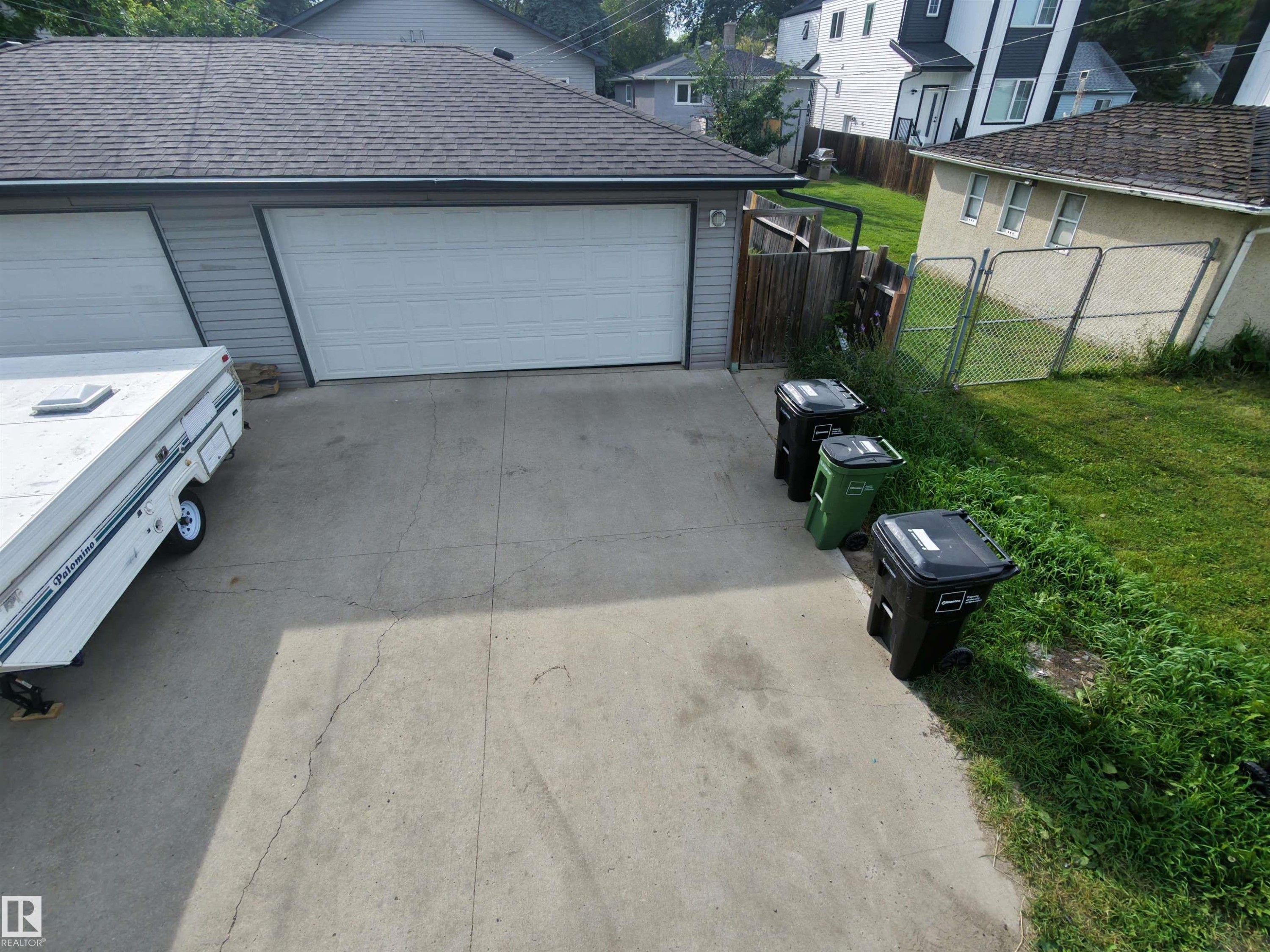 Two-car garage with white paneled doors and a shingled roof - 11625 88 Street Nw, Edmonton, AB