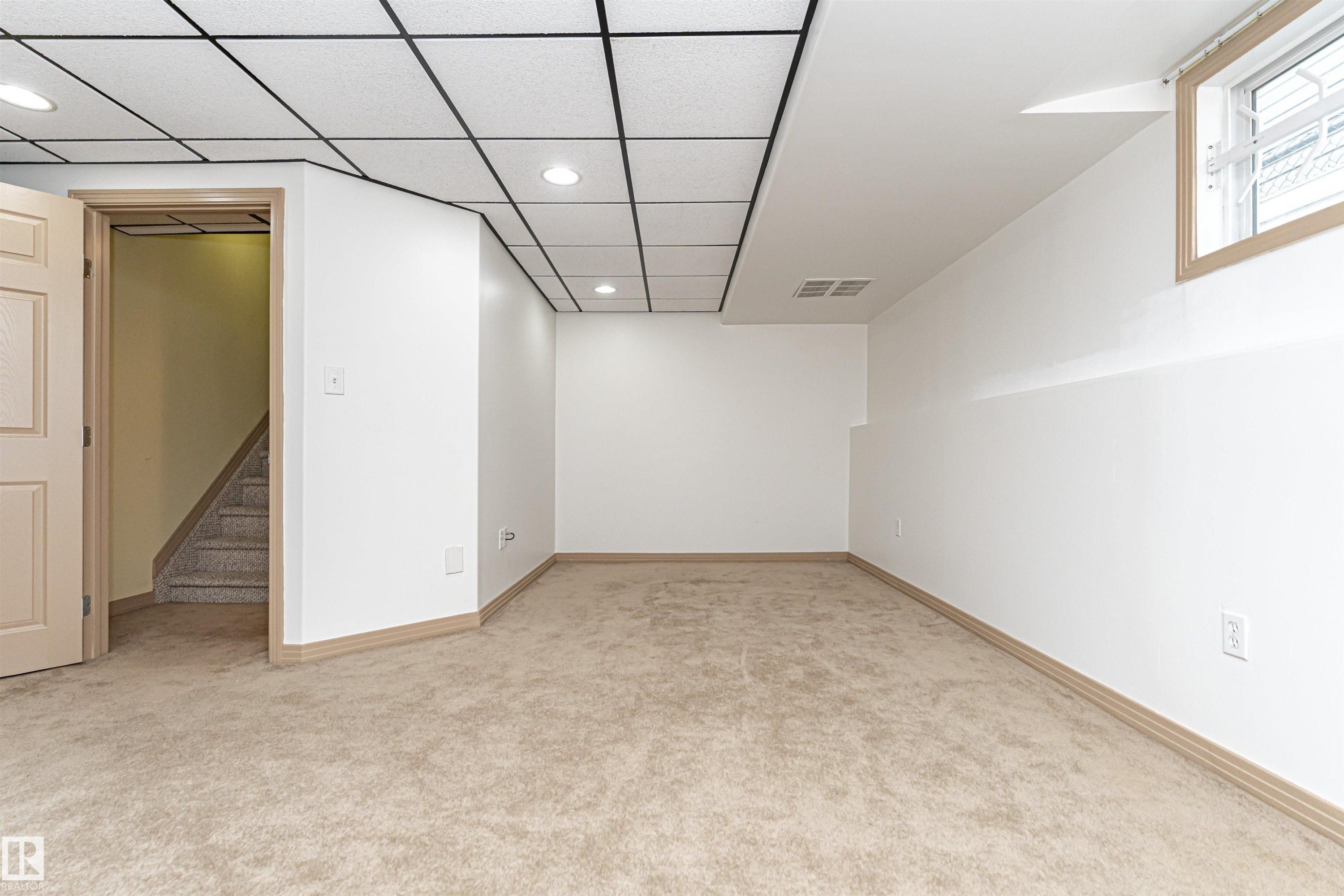 Finished lower level space featuring recessed lighting, a drop ceiling, and a light beige carpet - 12241 93 Street Nw, Edmonton, AB - Indoor Photo Showing Other Room
