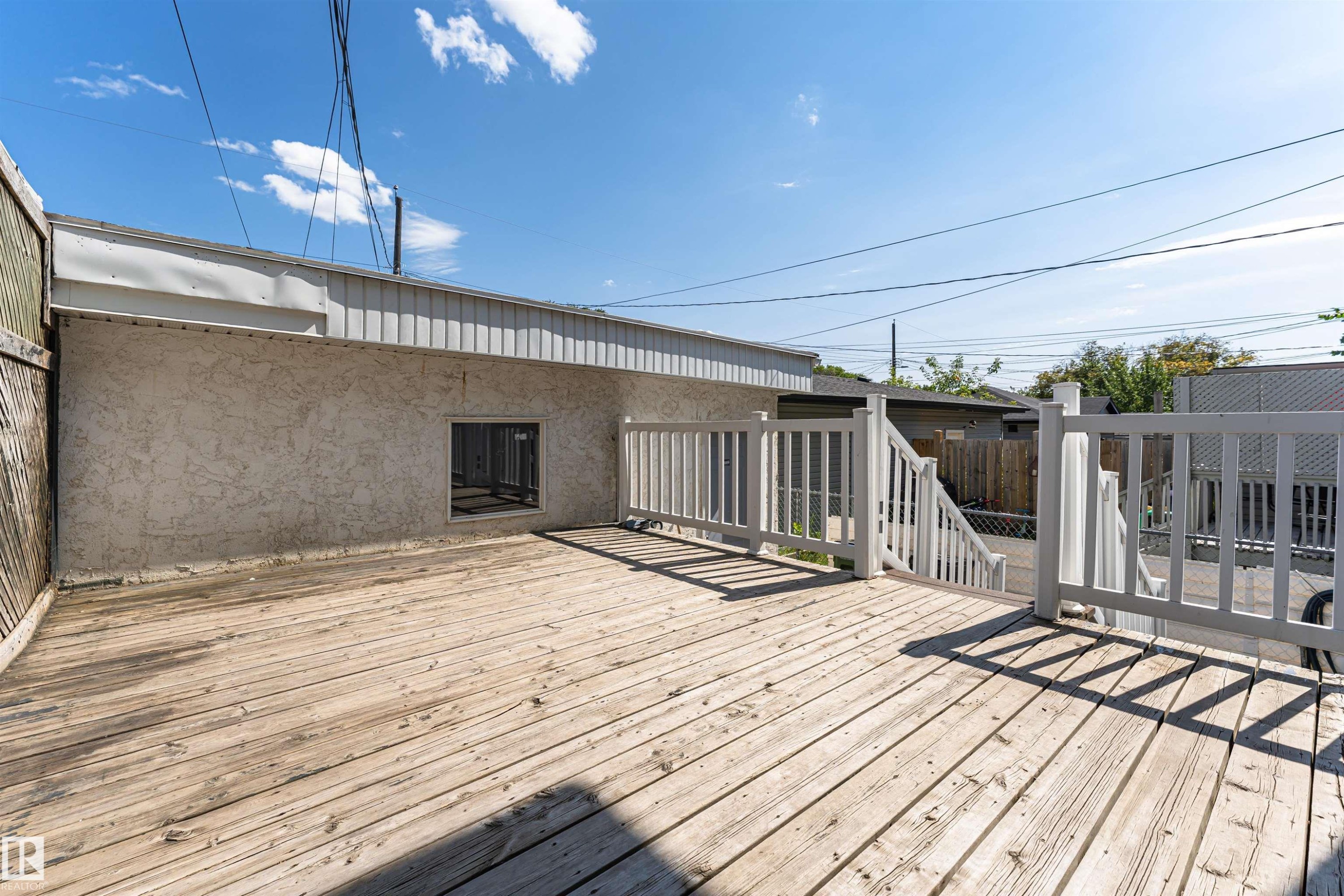 Outdoor wood deck featuring white painted railings and a staircase - 12241 93 Street Nw, Edmonton, AB - Outdoor With Deck Patio Veranda With Exterior
