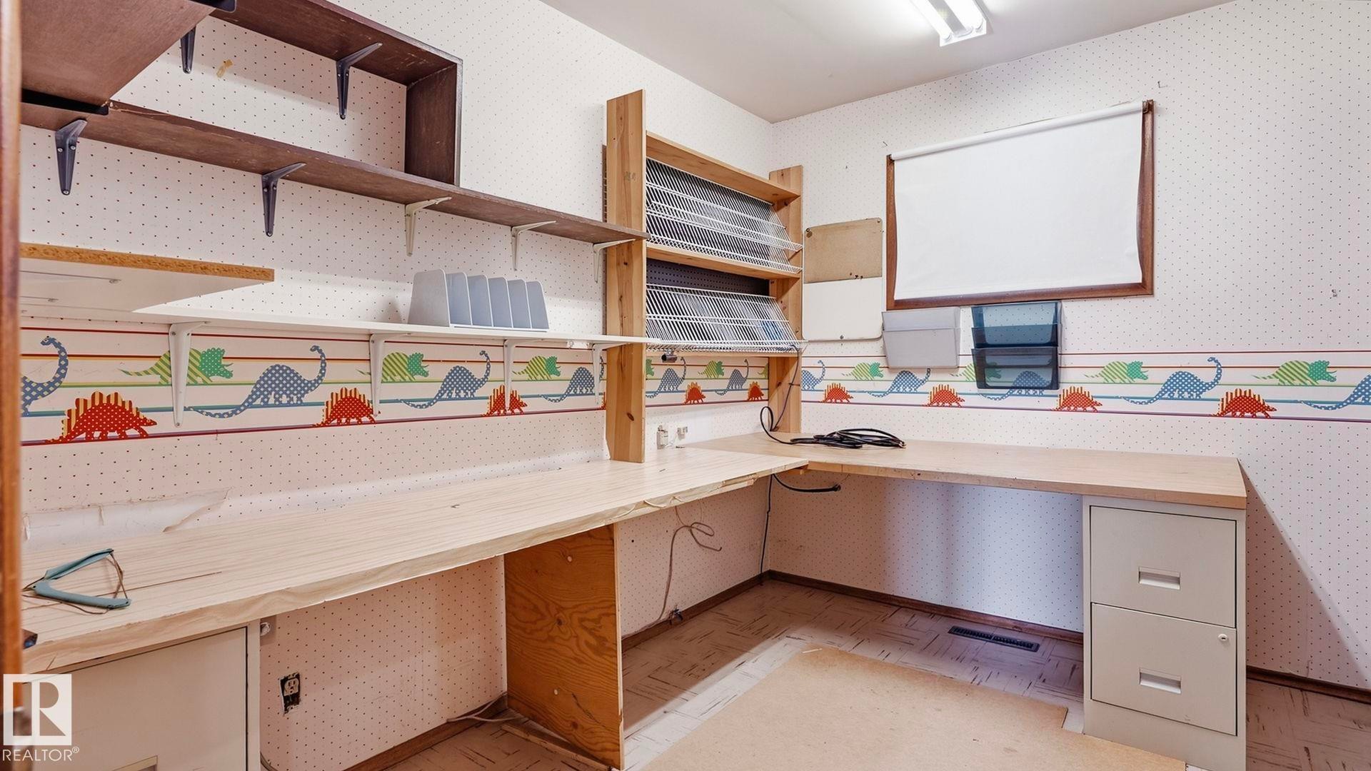 Built-in shelving, wood-finish countertops, and a window with a roller shade - 52012 Hwy 21, Rural Strathcona County, AB - Indoor