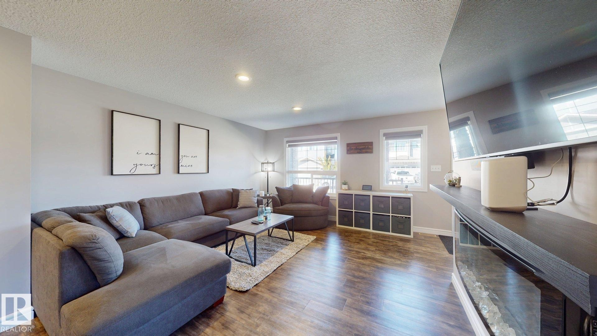 Recessed lighting, wood-finish flooring, and white trim - 17359 49 Street Nw, Edmonton, AB - Indoor Photo Showing Living Room