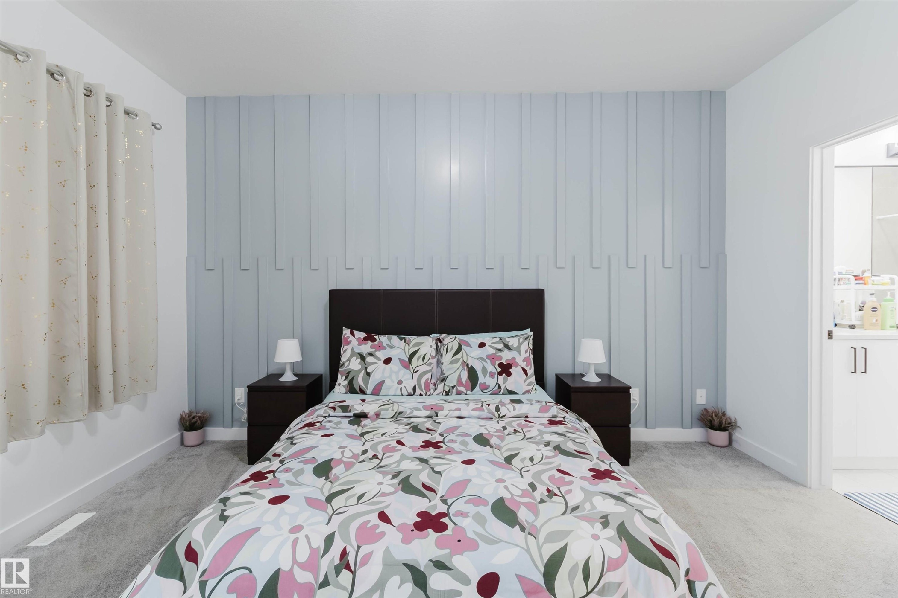 Feature wall with vertical paneling, plush carpet, white interior door, recessed lighting, and window with drapes - 104 Meadowview Way, Leduc, AB - Indoor Photo Showing Bedroom