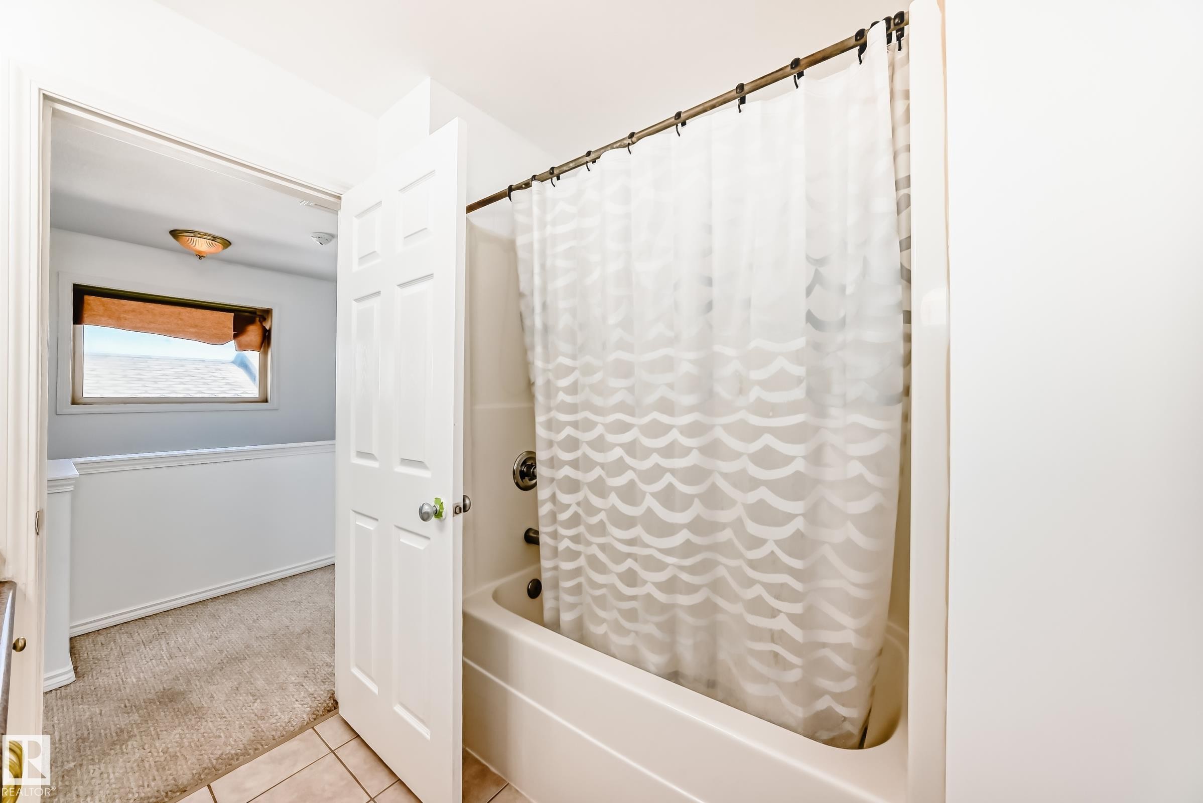 Tub and shower combination with tile flooring - 11727 83 Street Nw, Edmonton, AB - Indoor Photo Showing Bathroom