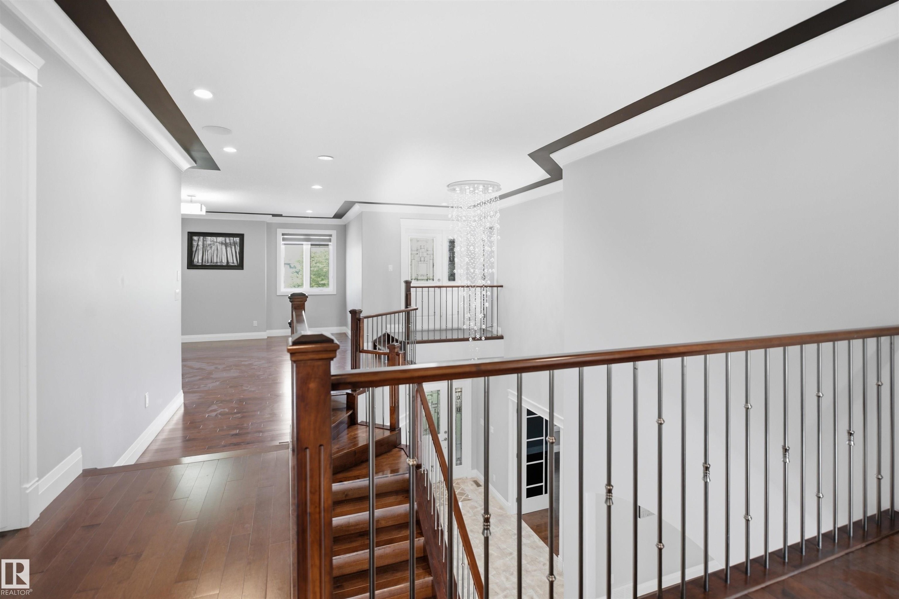 Hardwood flooring throughout, recessed lighting, and a contemporary chandelier - 427 Windermere Road Nw, Edmonton, AB - Indoor Photo Showing Other Room