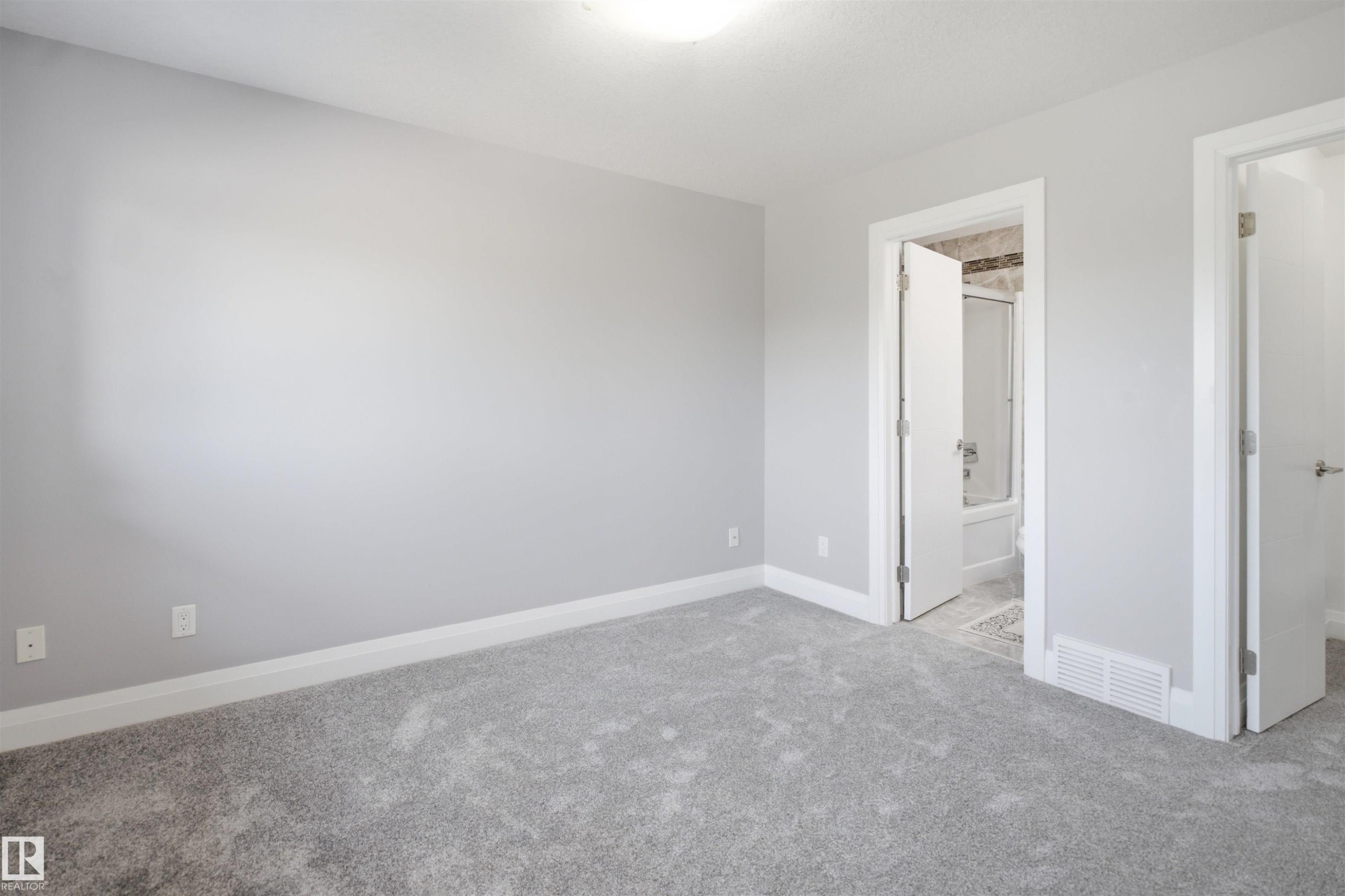 Plush gray carpeting, light gray wall finish, and white trim - 427 Windermere Road Nw, Edmonton, AB - Indoor Photo Showing Other Room