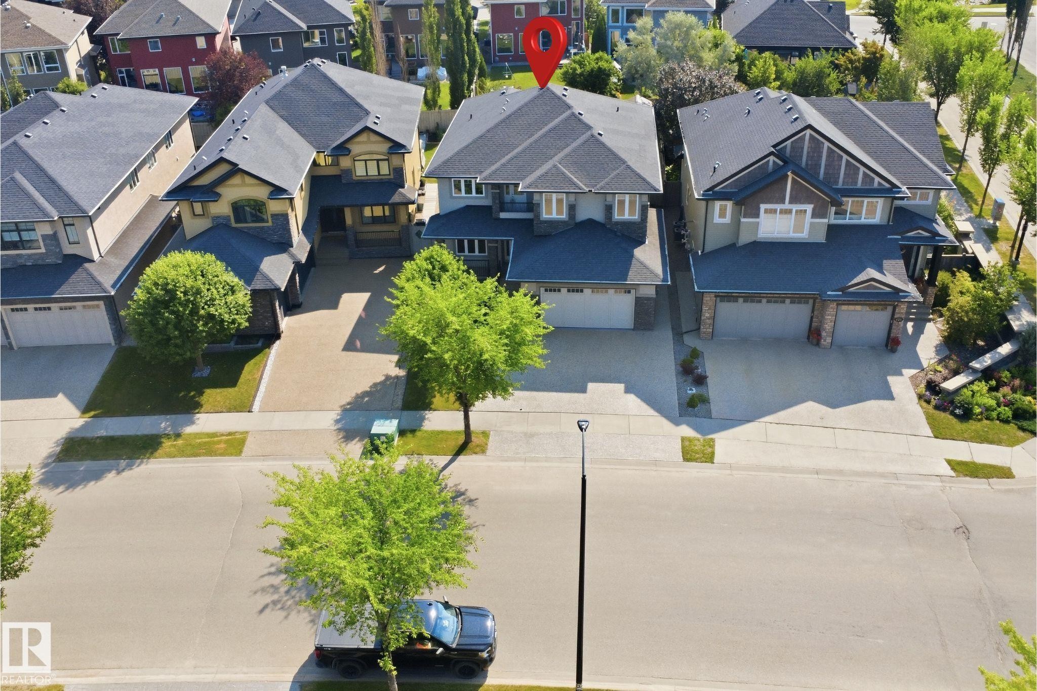 Two-story residence with a dark shingle roof and light-toned siding - 427 Windermere Road Nw, Edmonton, AB - Outdoor With Deck Patio Veranda With Facade