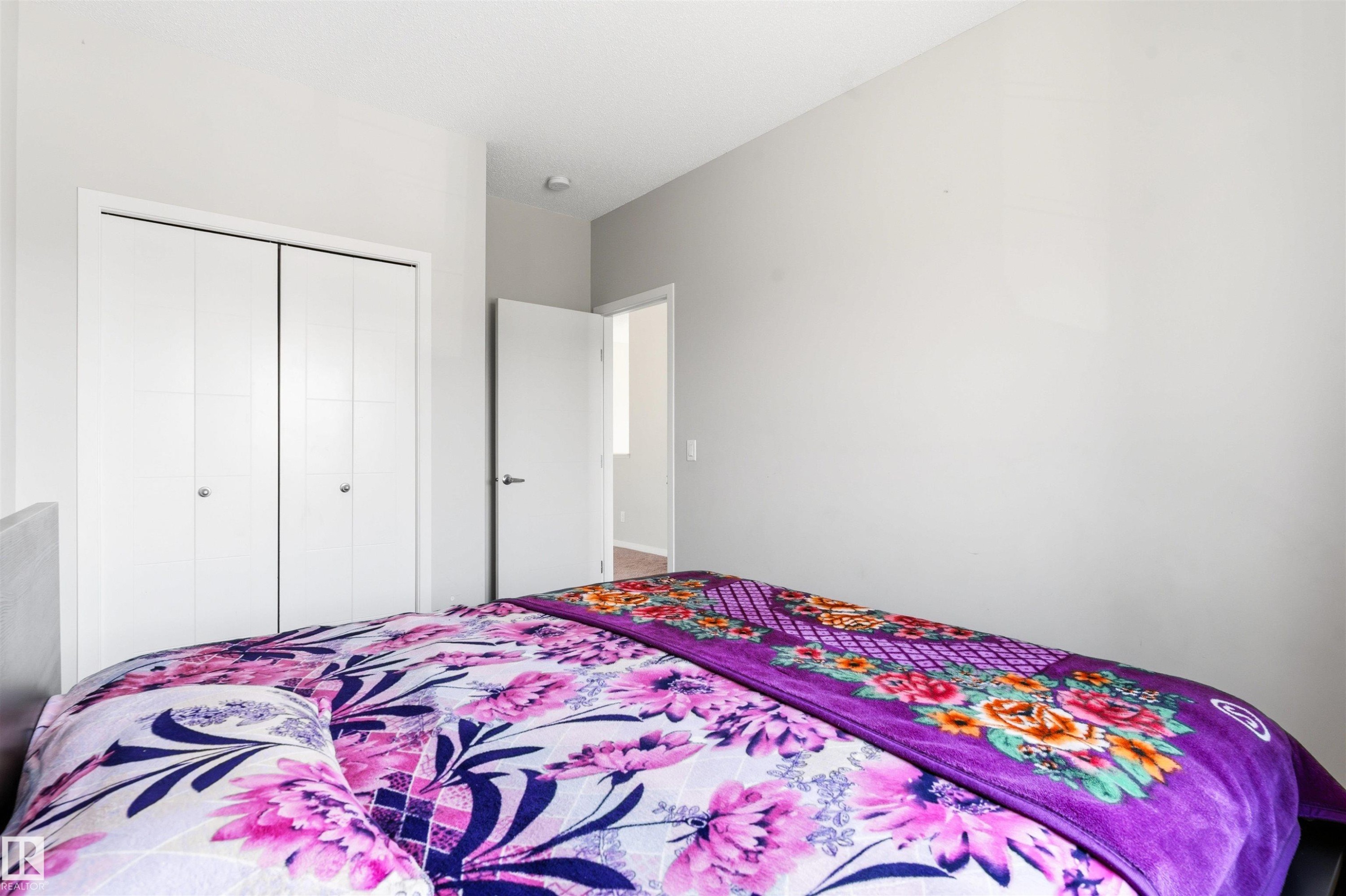 White bi-fold closet doors, light gray wall paint, and recessed ceiling lighting - 1103 26 Avenue Nw, Edmonton, AB