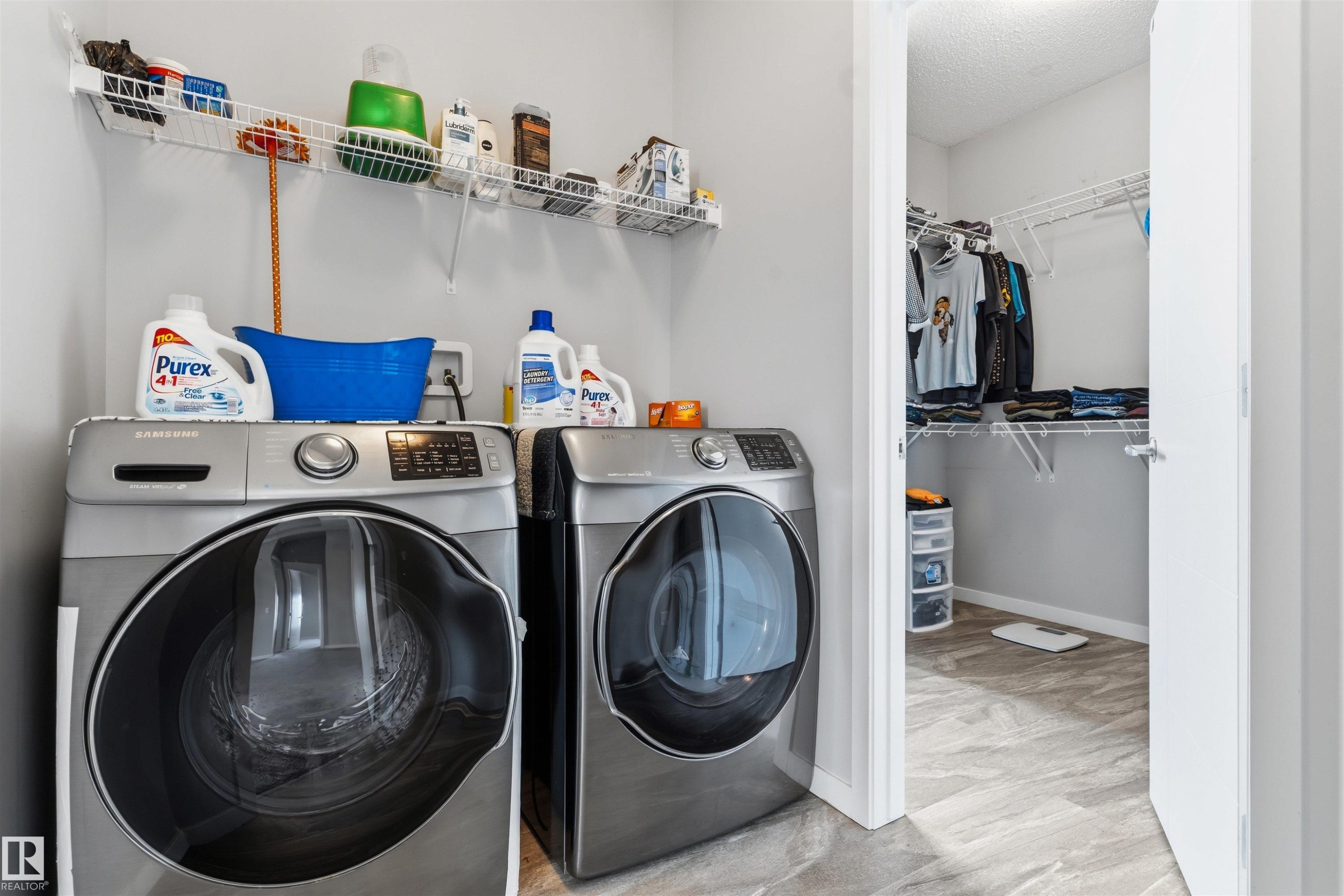 Laundry area featuring a front-load washer and dryer, wire shelving, and light gray wall paint - 1103 26 Avenue Nw, Edmonton, AB