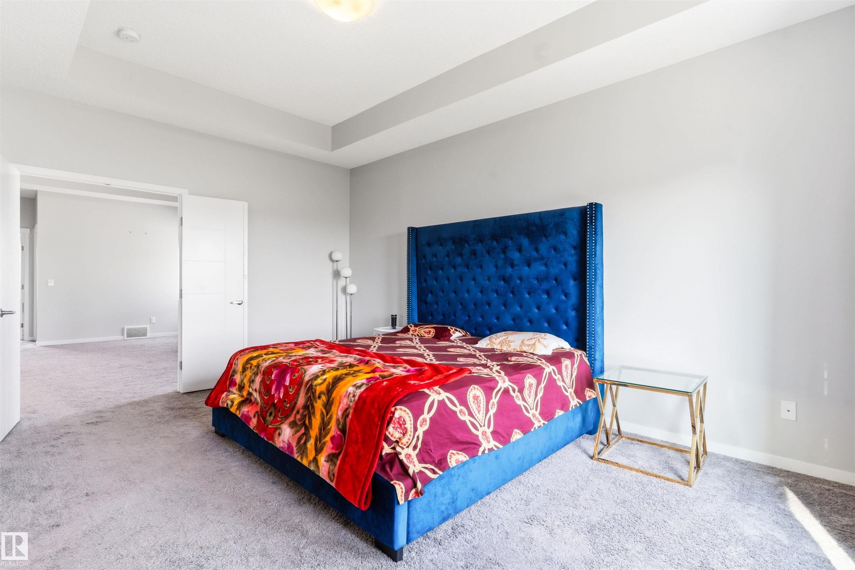 Tray ceiling with recessed lighting, light gray wall color, light gray carpet flooring, and a wide entryway - 1103 26 Avenue Nw, Edmonton, AB