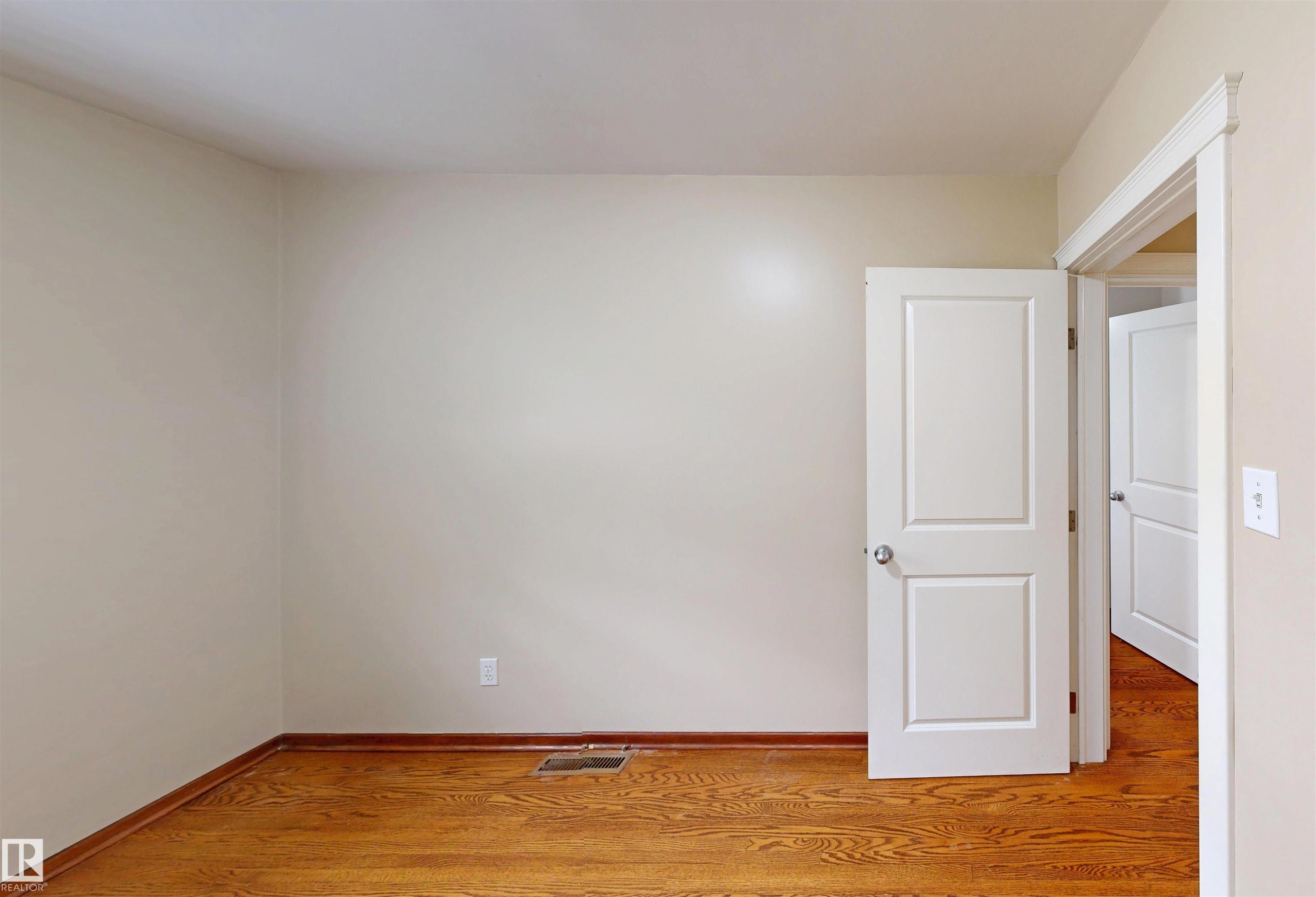 Wood-finish flooring - 9531 74 Street Nw, Edmonton, AB - Indoor Photo Showing Other Room