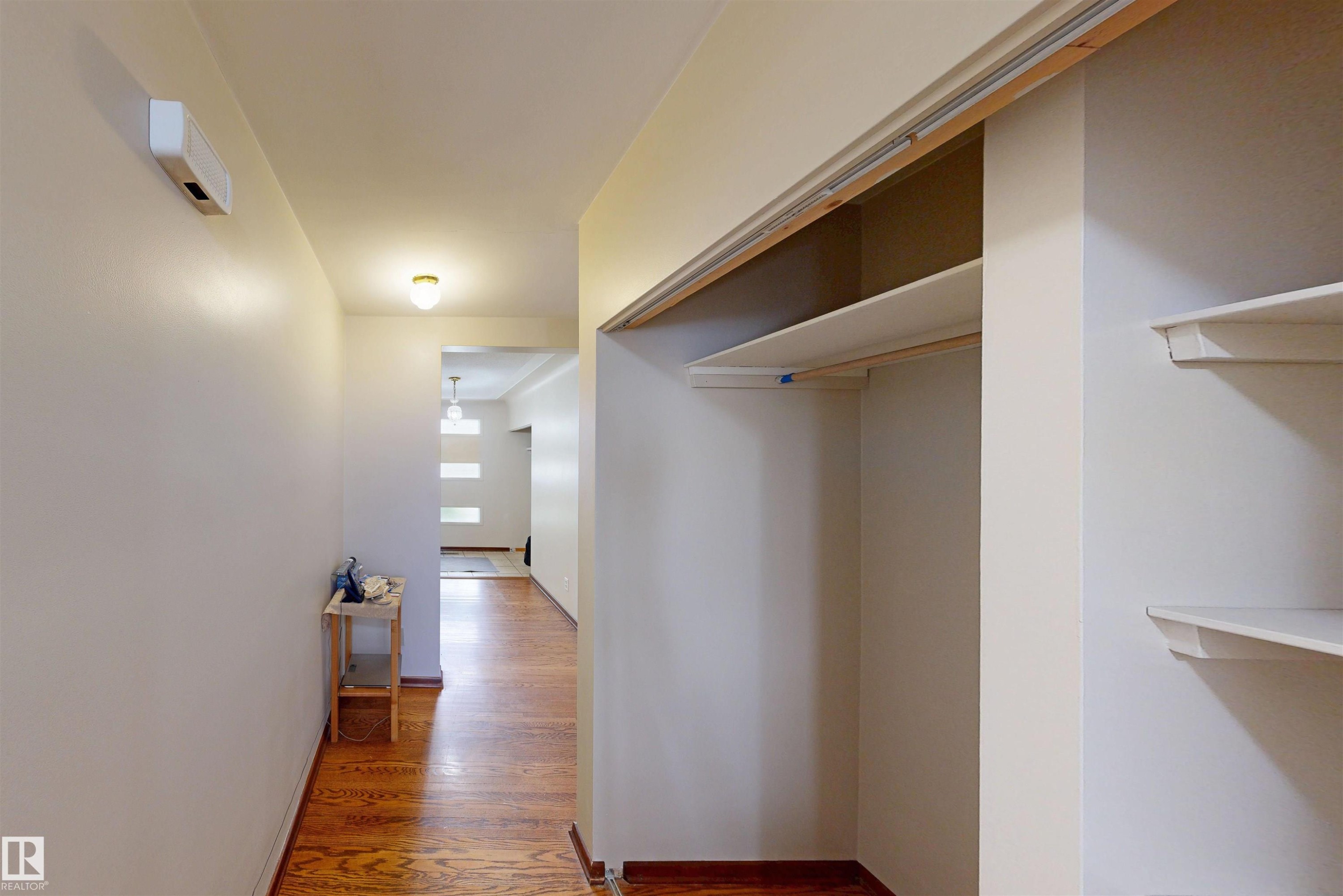 Hallway with wood-finish flooring and flush-mount lighting - 9531 74 Street Nw, Edmonton, AB - Indoor Photo Showing Other Room