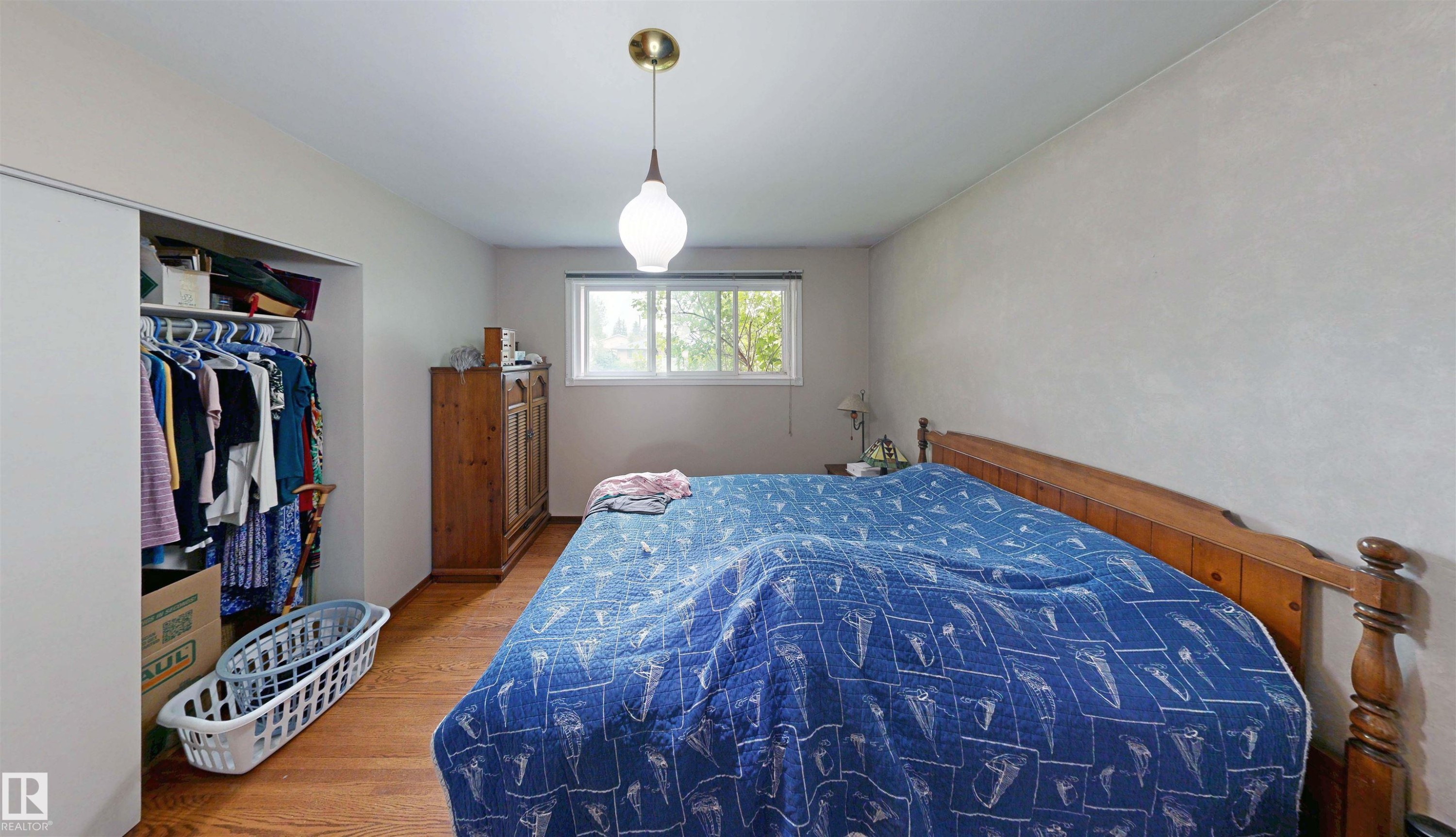 Wood-finish flooring, white walls, and a window with exterior visibility - 9531 74 Street Nw, Edmonton, AB - Indoor Photo Showing Bedroom
