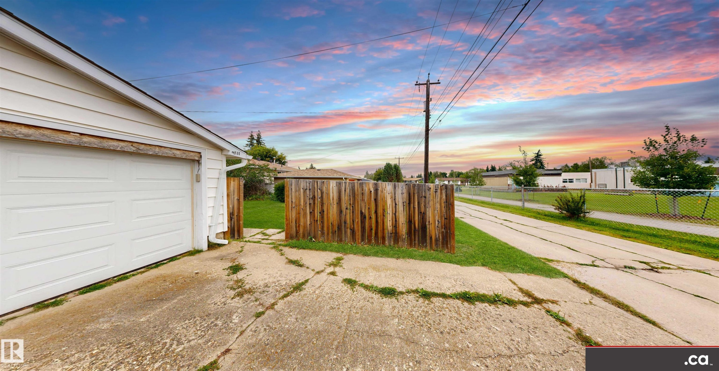 Detached garage with white siding, concrete driveway, and wood fencing - 9531 74 Street Nw, Edmonton, AB - Outdoor