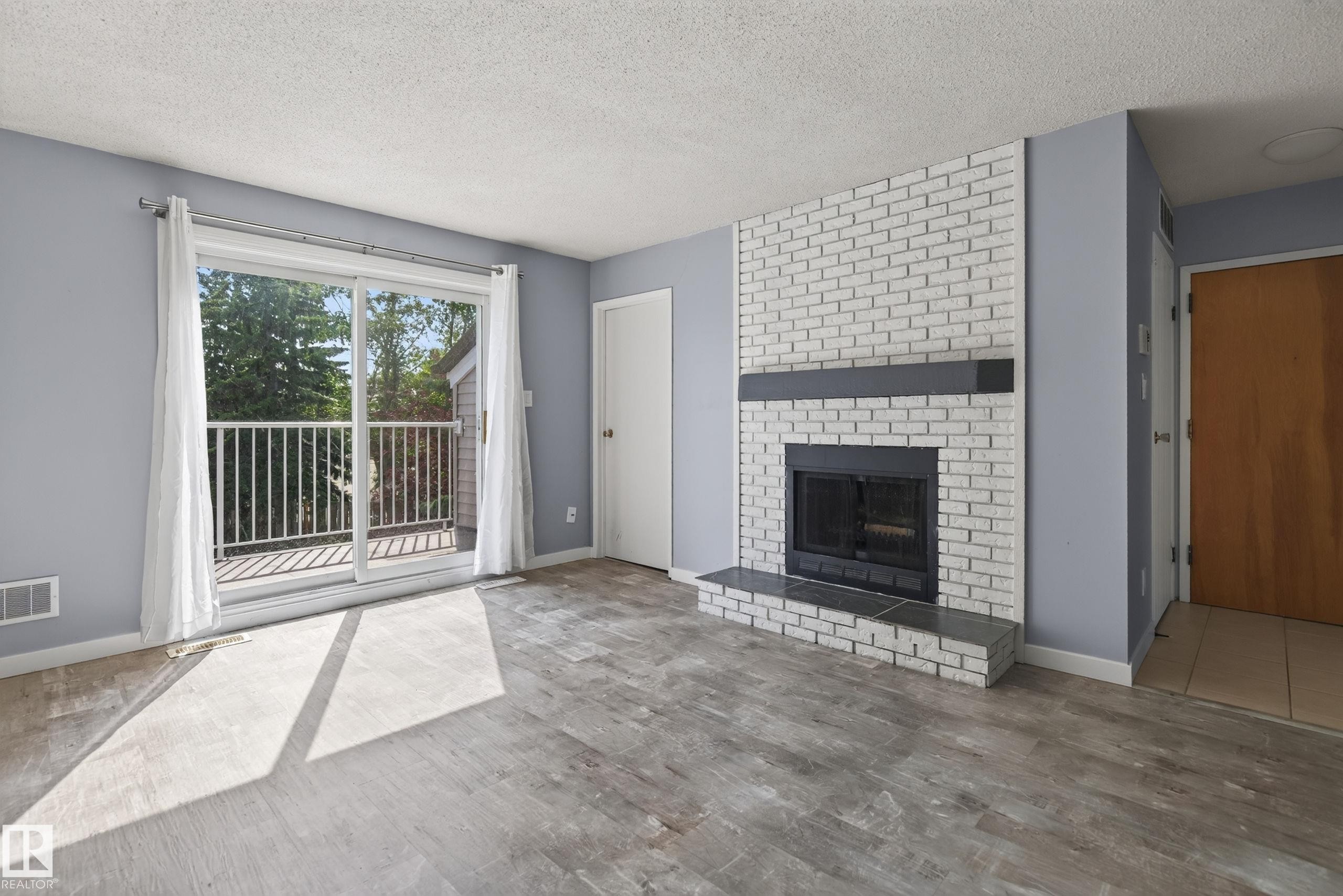 #304 24 Alpine Pl, St. Albert, AB - Indoor Photo Showing Living Room With Fireplace
