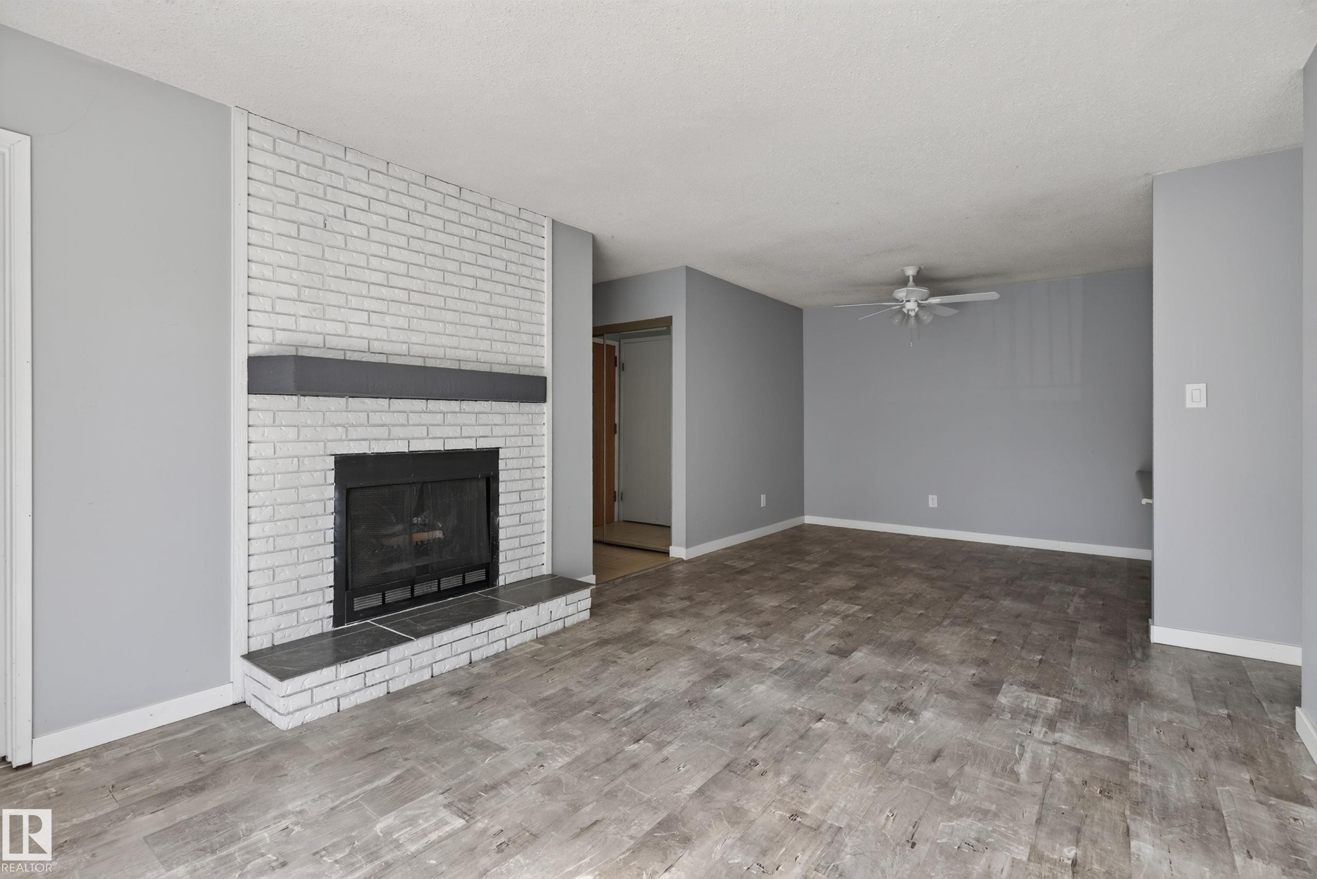#304 24 Alpine Pl, St. Albert, AB - Indoor Photo Showing Living Room With Fireplace