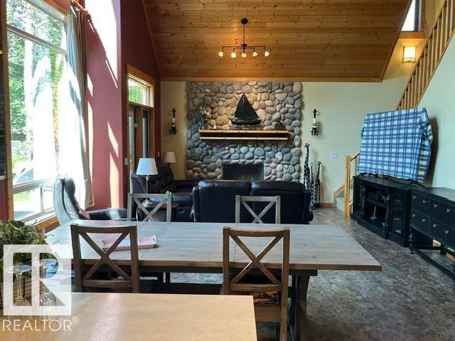 115 Sunset Boulevard, Rural Leduc County, AB - Indoor Photo Showing Dining Room With Fireplace