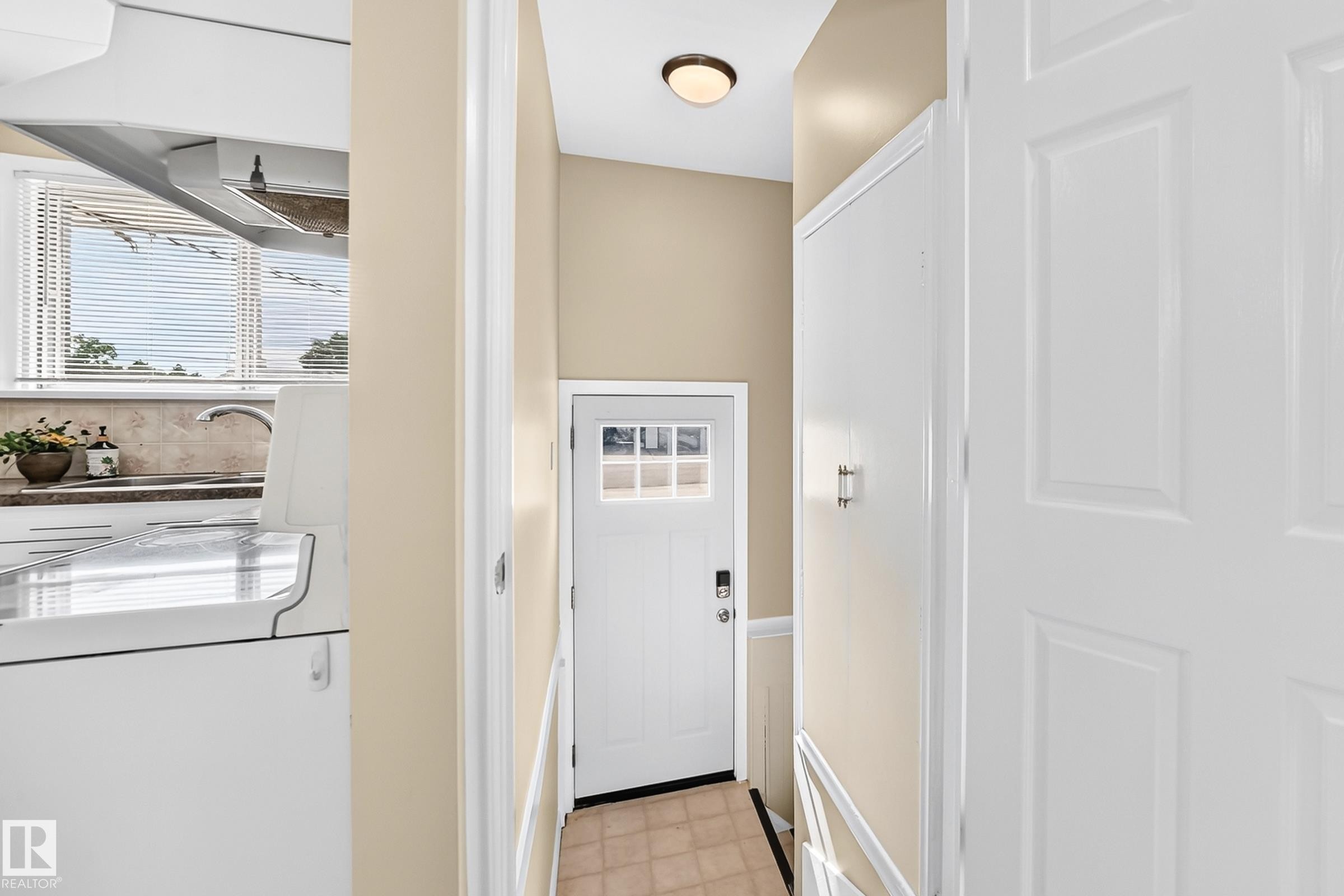 White paneled doors, recessed lighting, and a kitchen with an undermount sink and tiled backsplash - 50 Rocque, Fort Saskatchewan, AB - Indoor