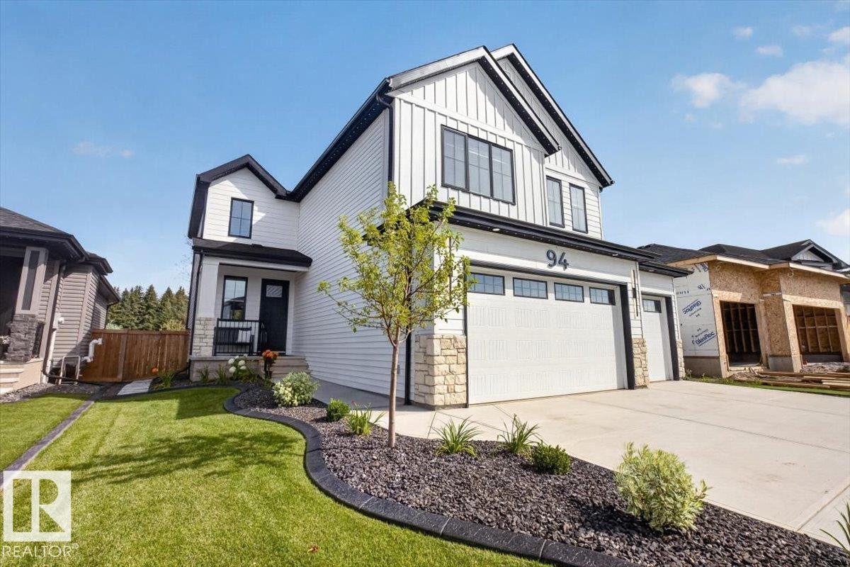 Contemporary exterior featuring white siding and black trim - 94 Harvest Crescent, Ardrossan, AB - Outdoor