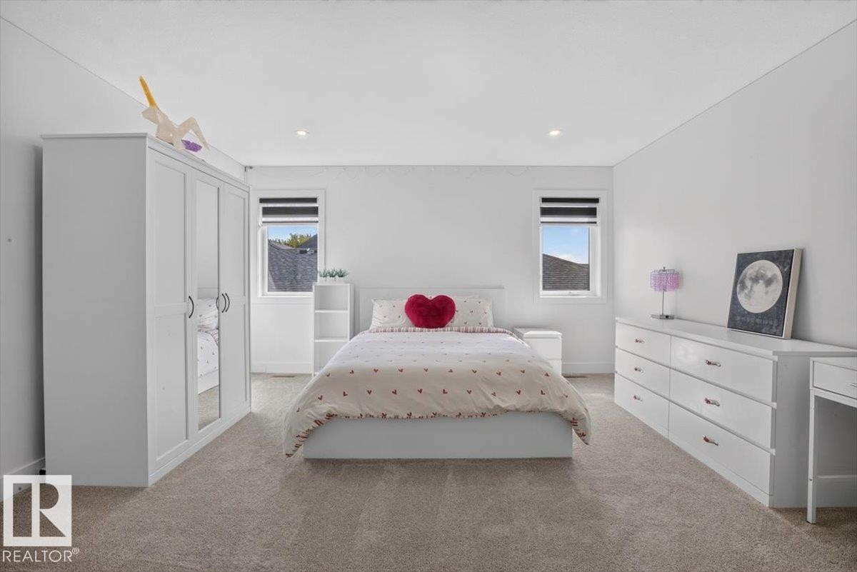 Carpeted flooring, recessed lighting, and dual windows with roller shades - 94 Harvest Crescent, Ardrossan, AB - Indoor Photo Showing Bedroom