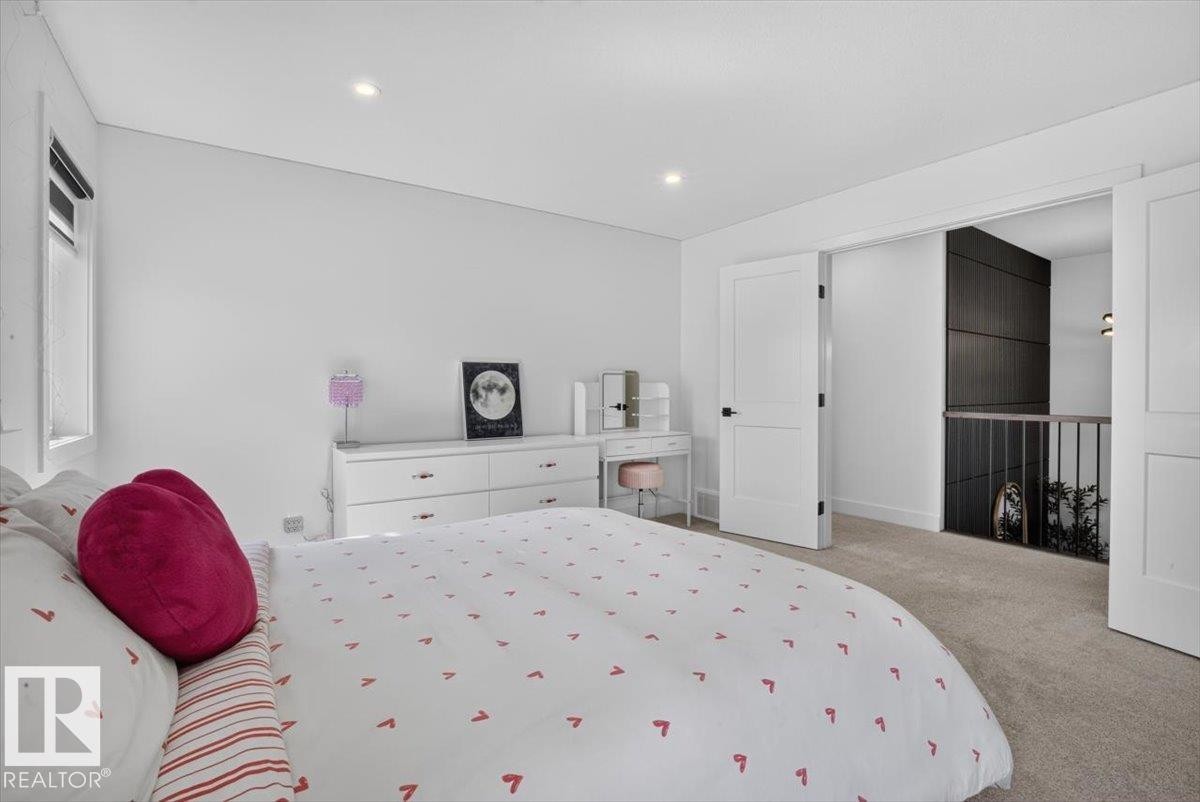 Recessed ceiling lighting, a window with roller shades, white walls, and carpeted flooring - 94 Harvest Crescent, Ardrossan, AB - Indoor Photo Showing Bedroom