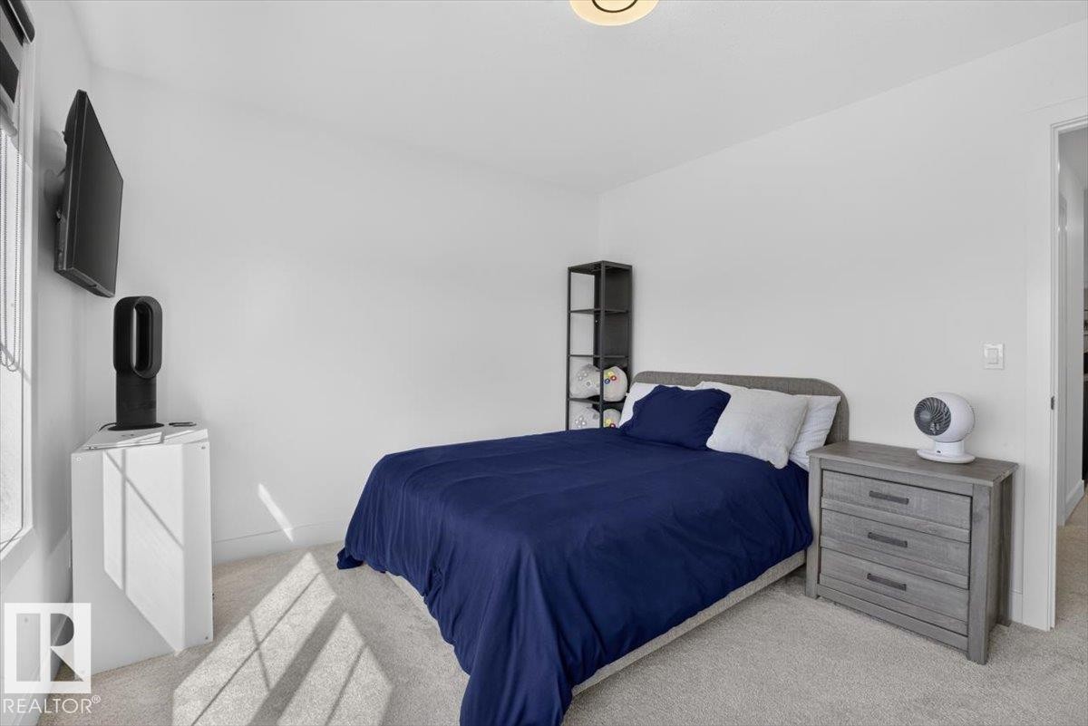 Light-colored wall-to-wall carpeting, white walls, and a flush-mount ceiling light fixture - 94 Harvest Crescent, Ardrossan, AB - Indoor Photo Showing Bedroom