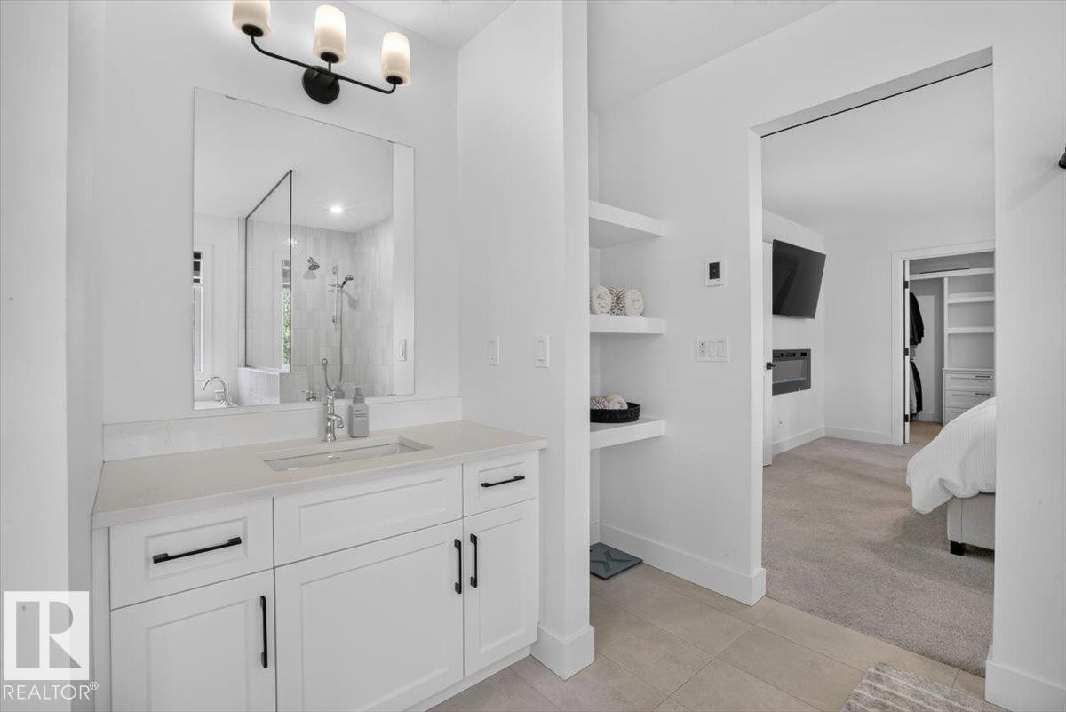 White shaker-style vanity with a light-toned countertop and undermount sink - 94 Harvest Crescent, Ardrossan, AB - Indoor Photo Showing Bathroom
