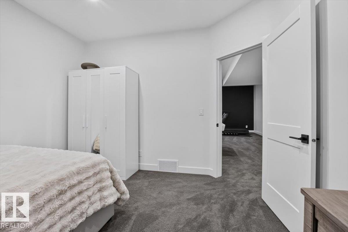 Neutral wall color with dark carpeting - 94 Harvest Crescent, Ardrossan, AB - Indoor Photo Showing Bedroom