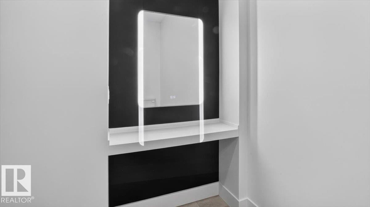 Built-in alcove featuring an integrated lighted mirror and a white floating shelf - 94 Harvest Crescent, Ardrossan, AB - Indoor Photo Showing Other Room