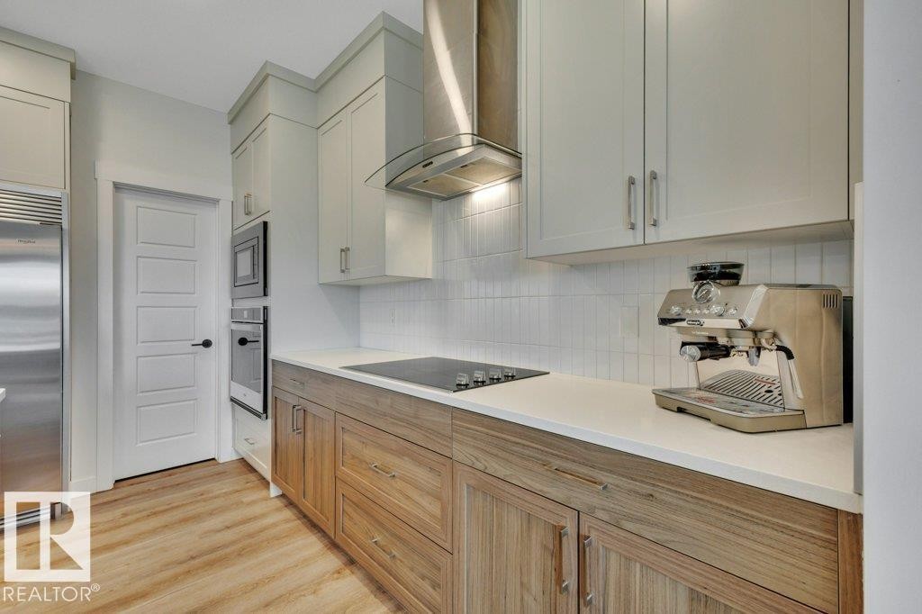 Quartz countertops and stainless steel appliances - 5329 Lark Landing Nw, Edmonton, AB - Indoor Photo Showing Kitchen