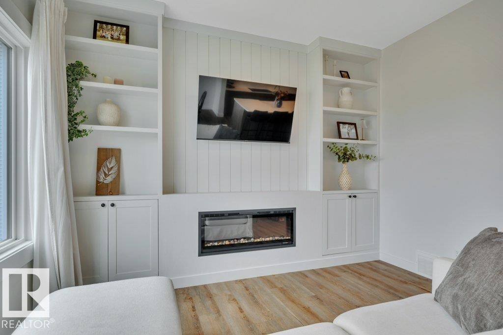 Electric fireplace, TV and wall mount included - 5329 Lark Landing Nw, Edmonton, AB - Indoor Photo Showing Living Room With Fireplace