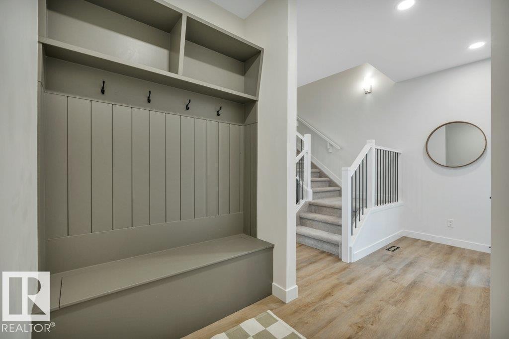 At garage entrance with bench storage and custom finish carpentry - 5329 Lark Landing Nw, Edmonton, AB - Indoor Photo Showing Other Room