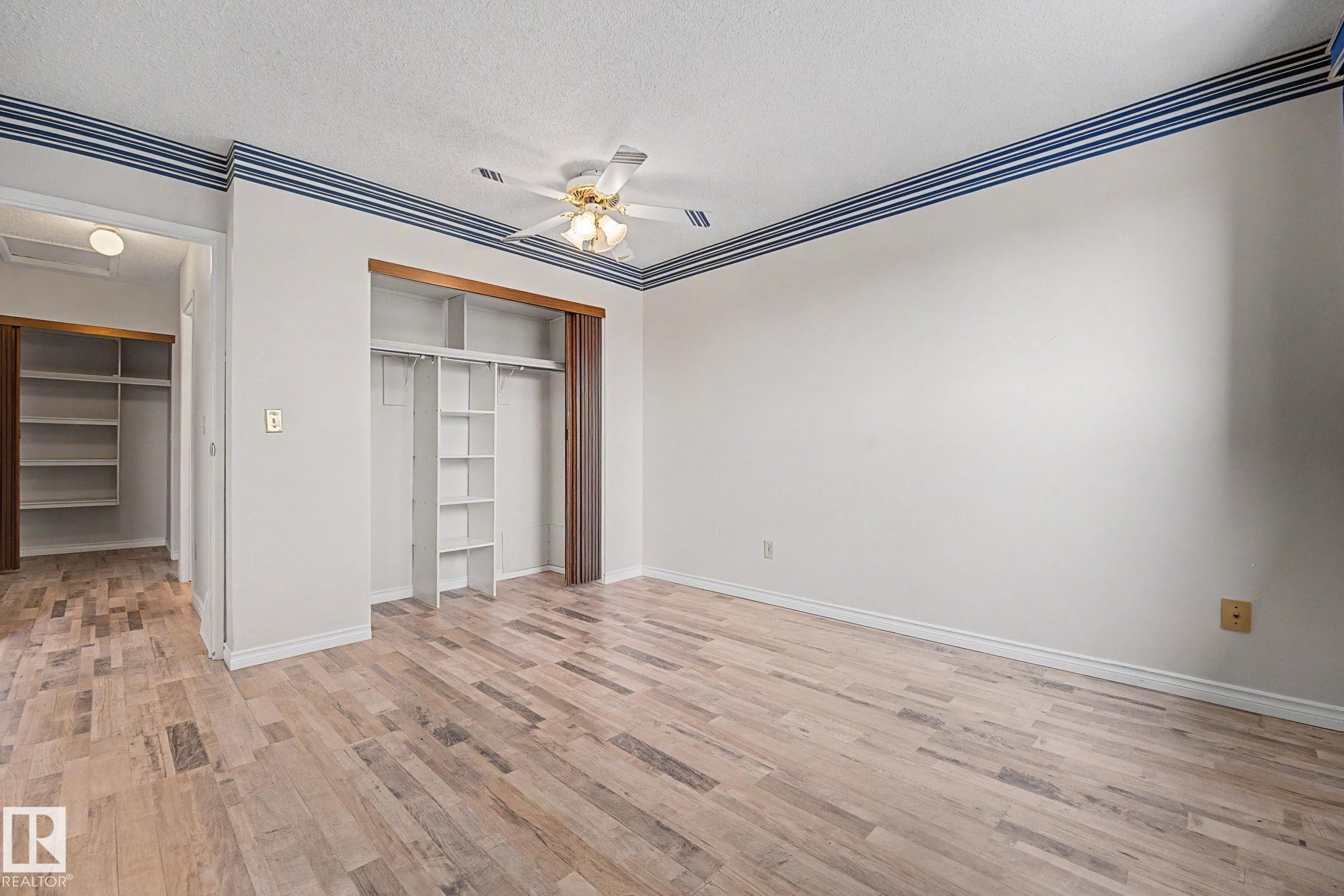 Light wood-finish flooring throughout - 1096 Knottwood Road Nw, Edmonton, AB - Indoor Photo Showing Other Room