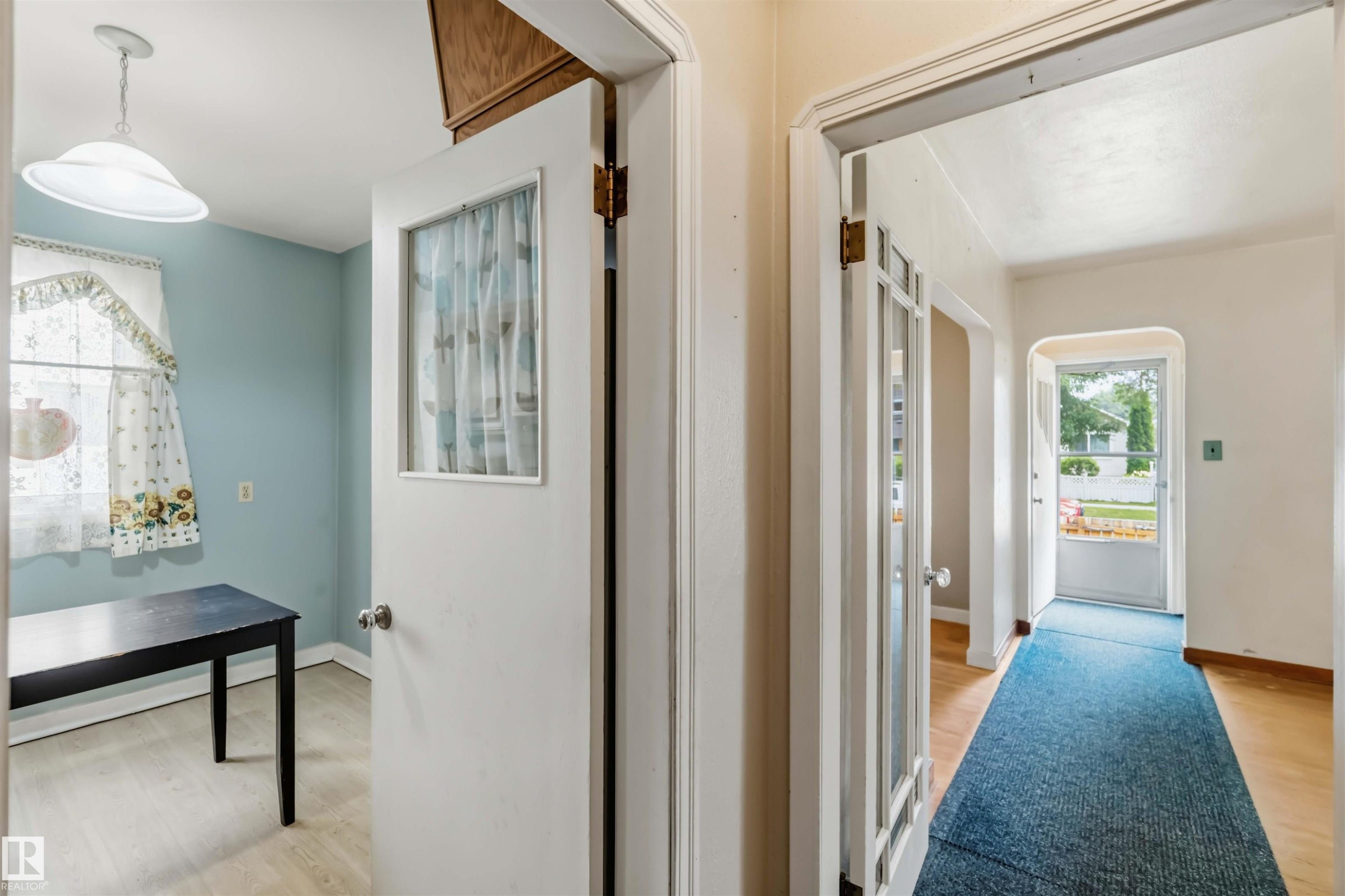 Interior doorway with glass paneling and an overhead light fixture - 11710 94 Street Nw, Edmonton, AB - Indoor Photo Showing Kitchen