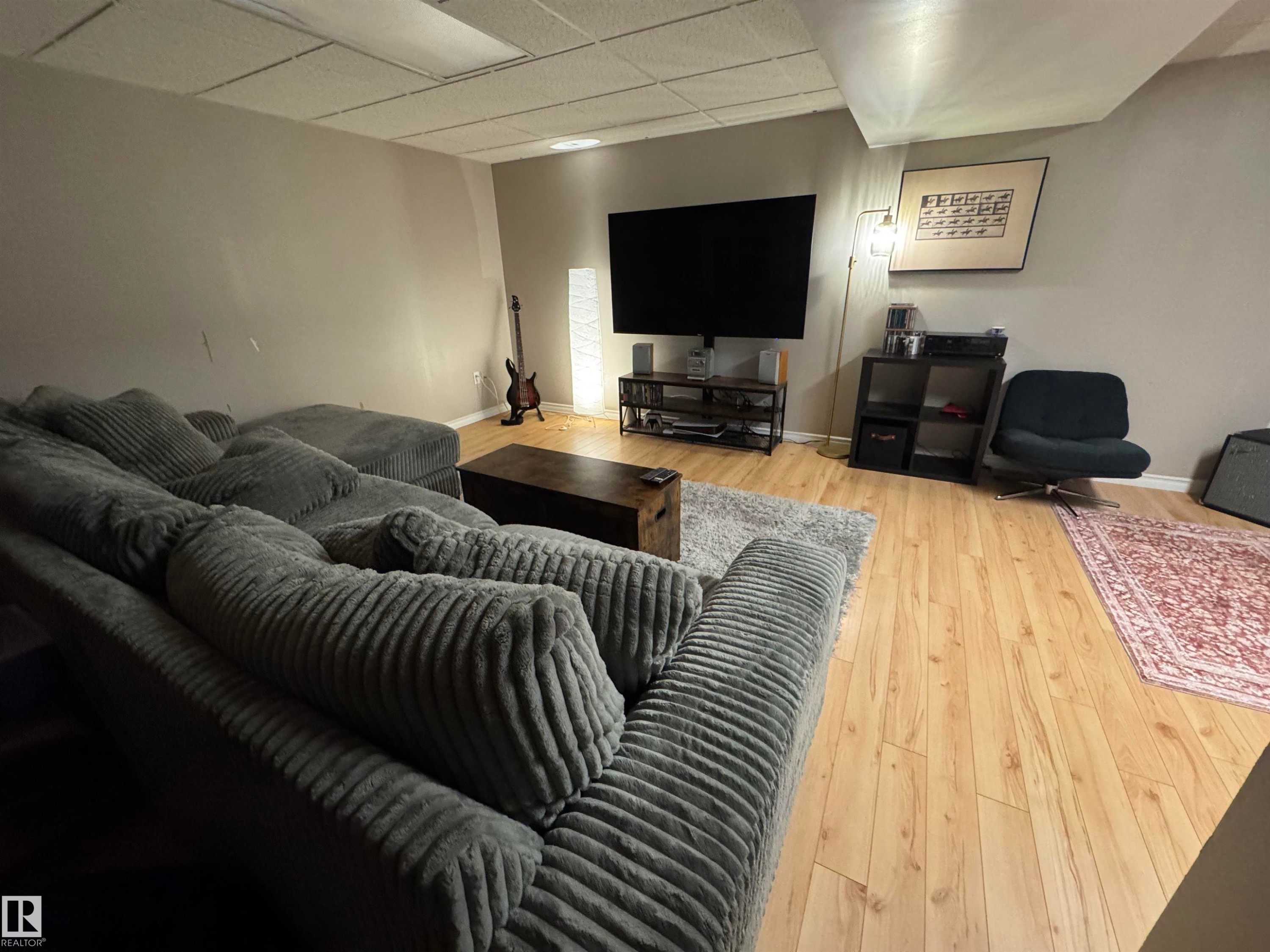 Recessed ceiling panels, light-toned wall paint, and wood-finish flooring - #38 8930 99 Av, Fort Saskatchewan, AB