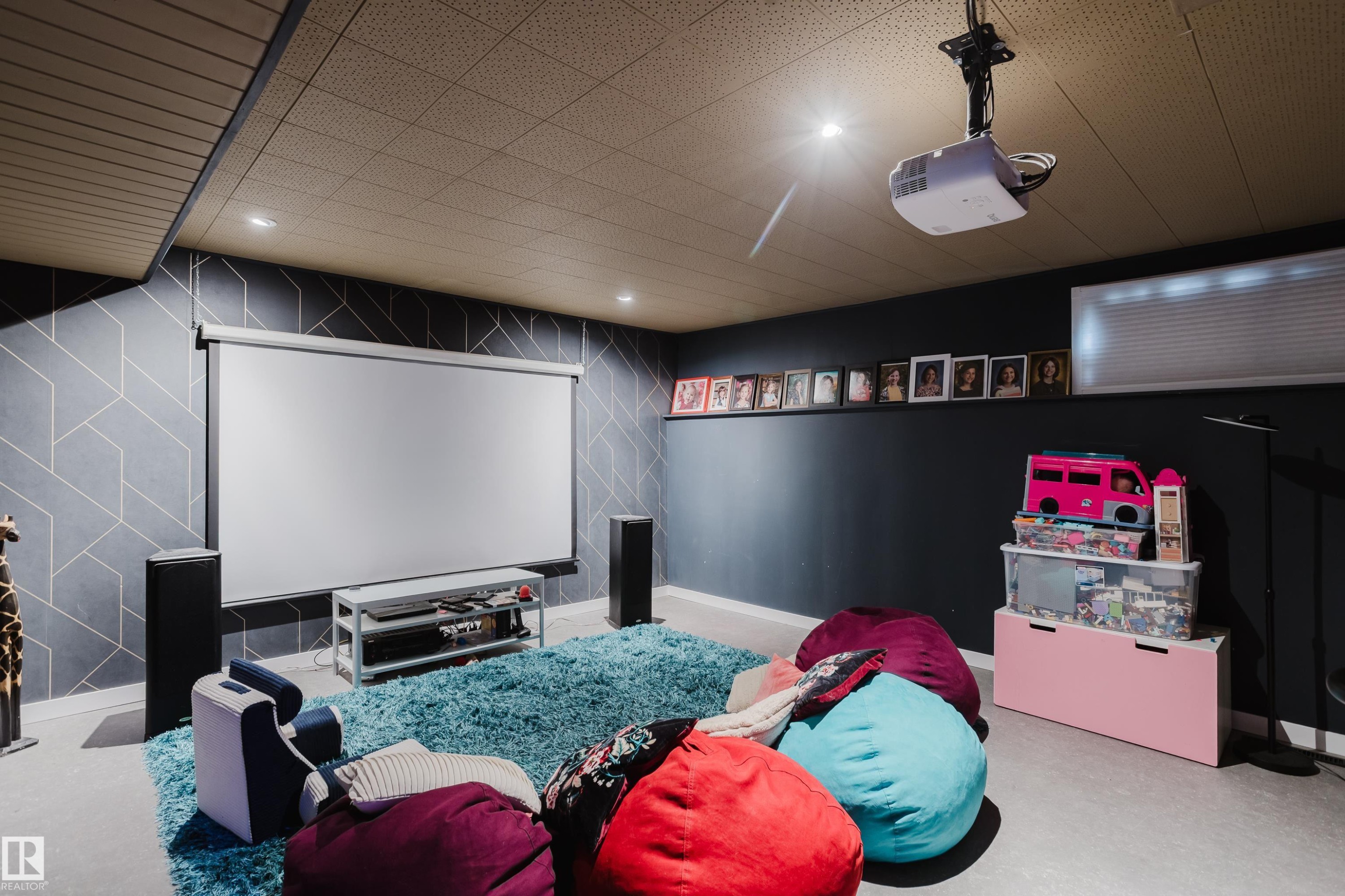 Media room featuring a drop ceiling with recessed lighting, a mounted projector, and a pull-down screen - 9059 52 Street Nw, Edmonton, AB - Indoor