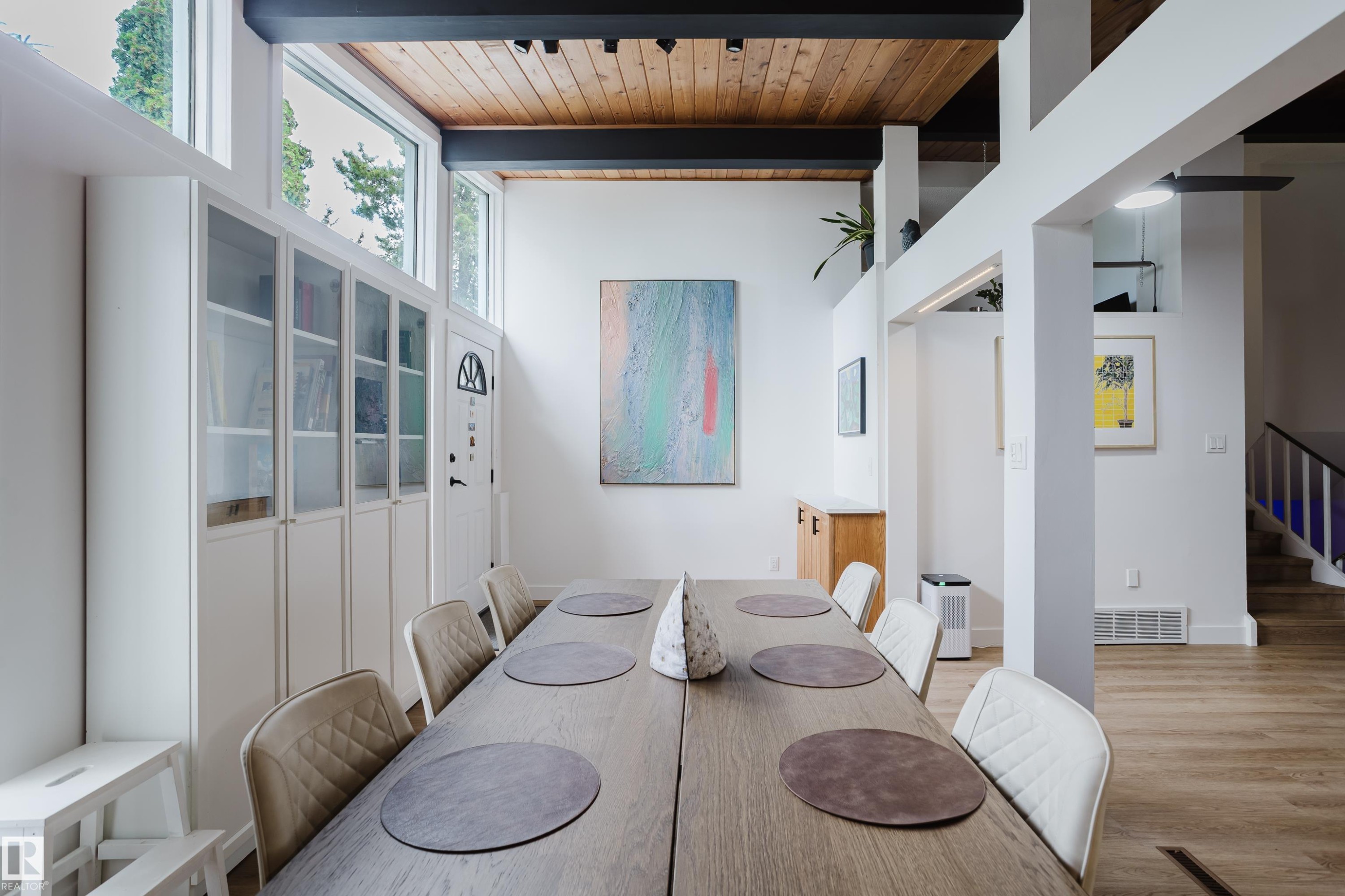 Vaulted wood-paneled ceiling with exposed structural beams, built-in display cabinetry, clerestory windows, and light wood-finish flooring - 9059 52 Street Nw, Edmonton, AB - Indoor Photo Showing Dining Room