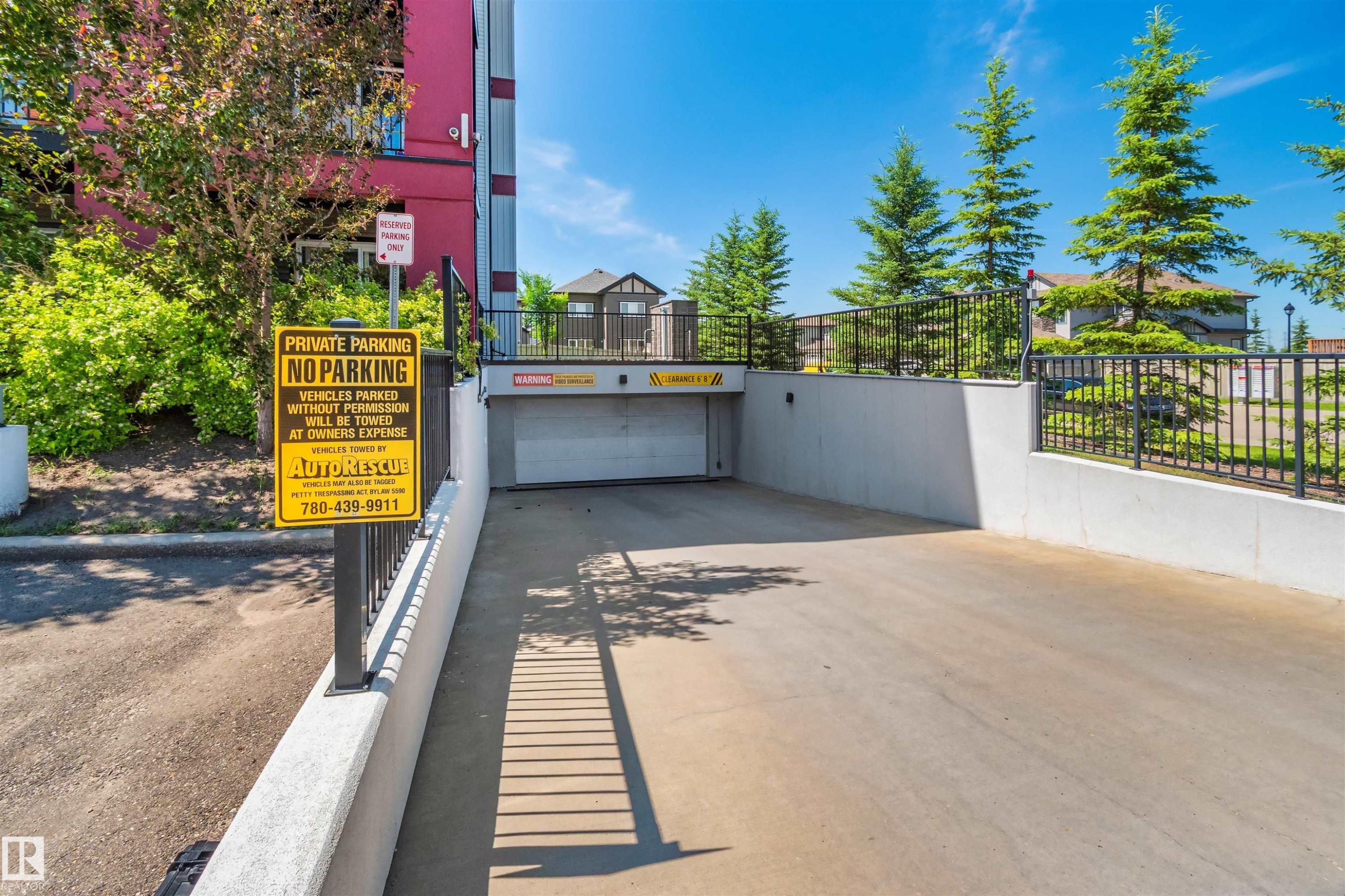 Concrete driveway leading to an underground parking garage - #318 5521 7 Av Sw Sw, Edmonton, AB - Outdoor