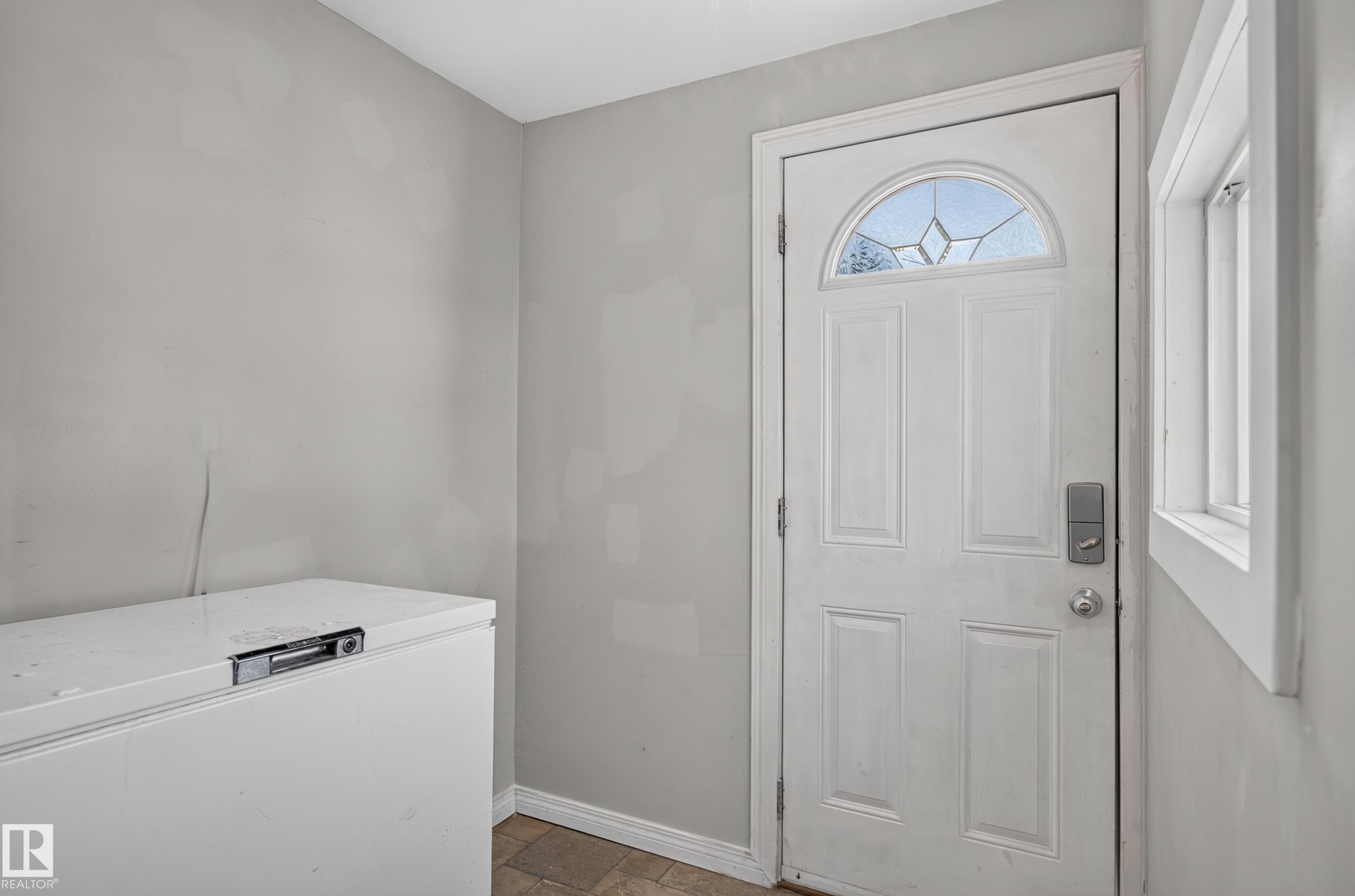 Entry door with an arched decorative glass insert and paneled design - 13214 123 Street Nw, Edmonton, AB