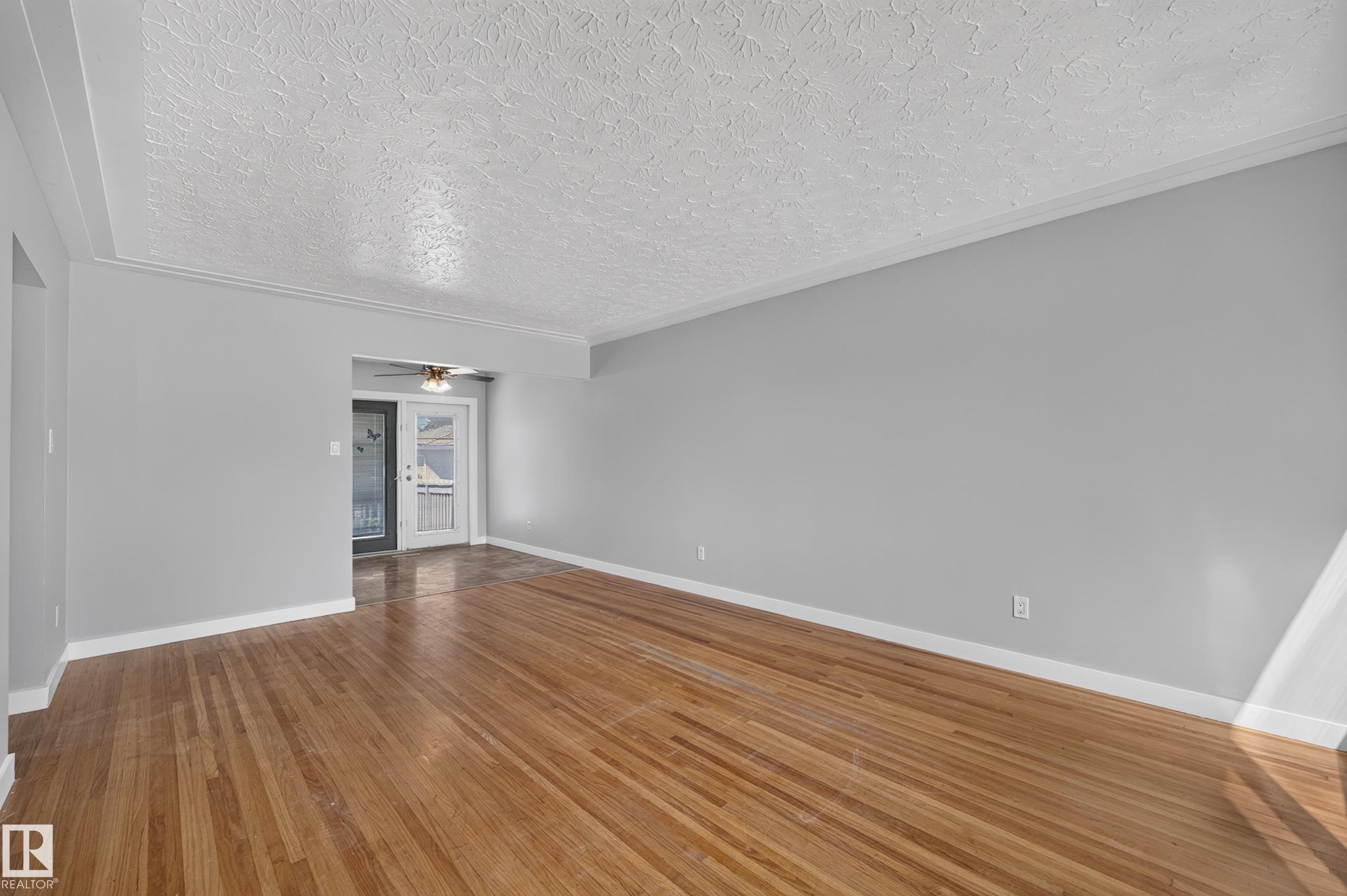Hardwood flooring, painted walls, crown molding, ceiling fan, and French doors - 13214 123 Street Nw, Edmonton, AB