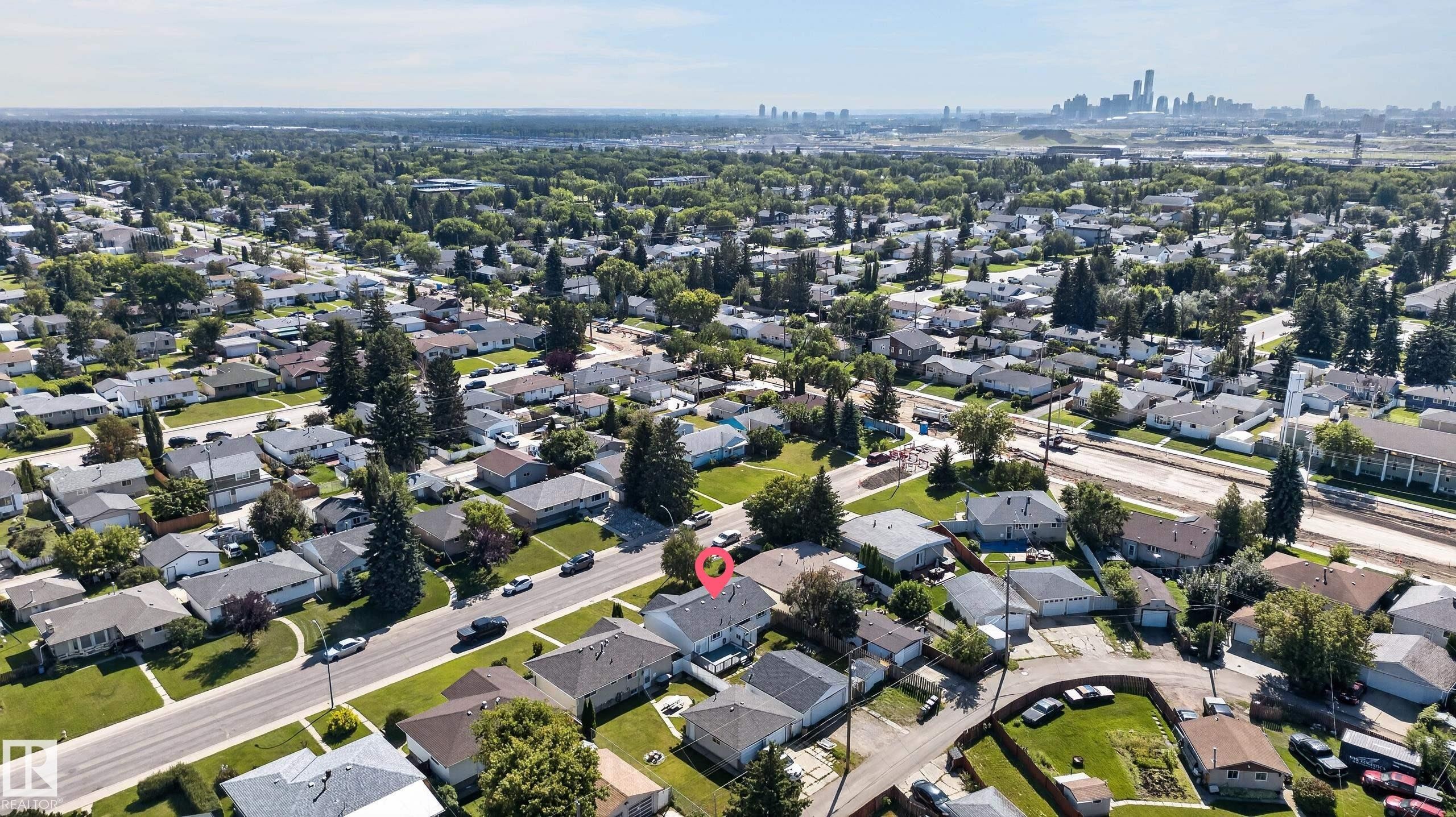 Aerial perspective showcasing a residential neighborhood with a distant cityscape - 13214 123 Street Nw, Edmonton, AB