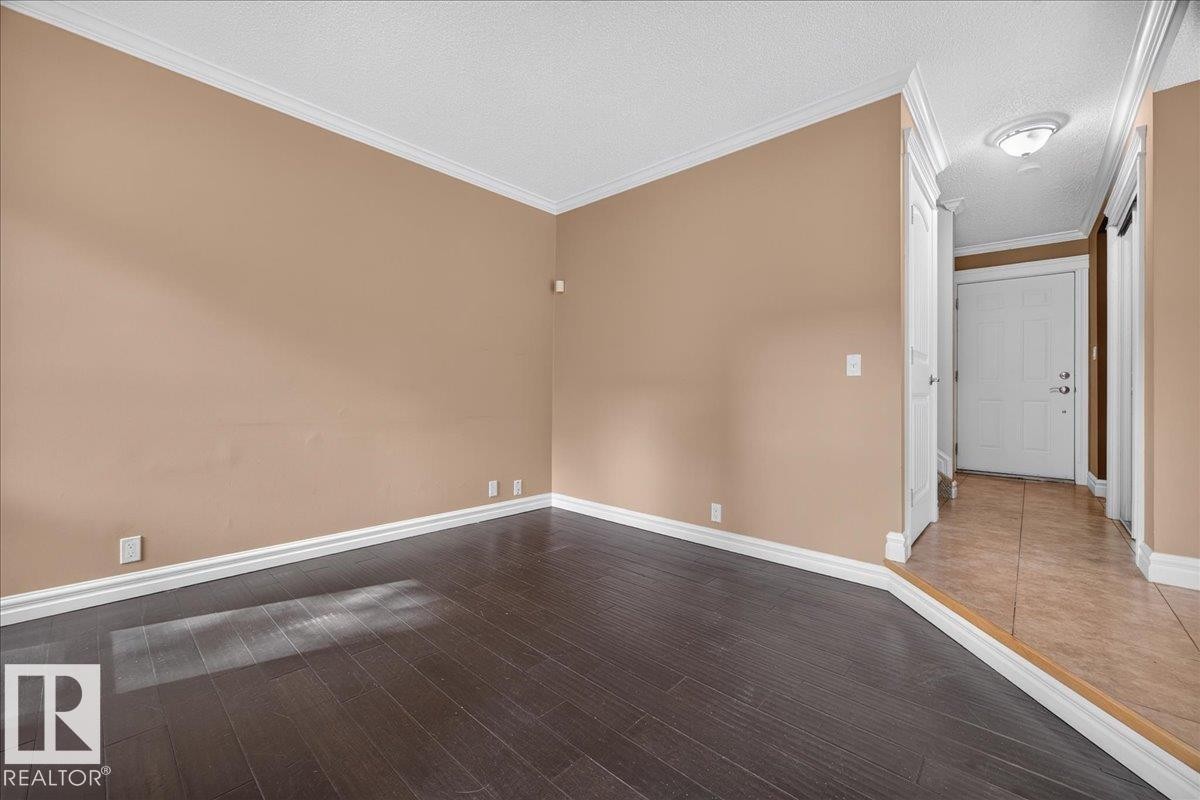 Wood-finish flooring, crown molding, and neutral wall tones - #47 3812 20 Av Nw, Edmonton, AB