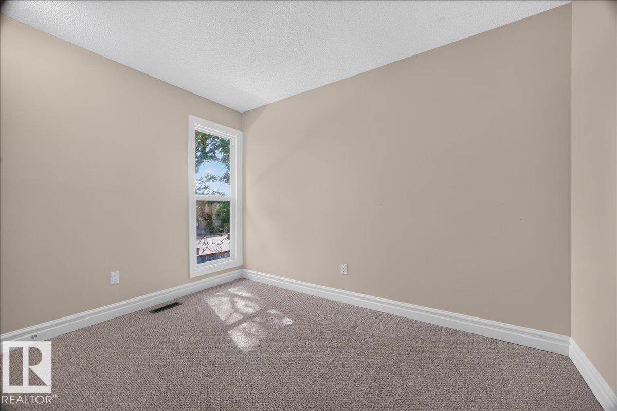 Light neutral wall paint, white trim, textured carpeting, and a single window - #47 3812 20 Av Nw, Edmonton, AB